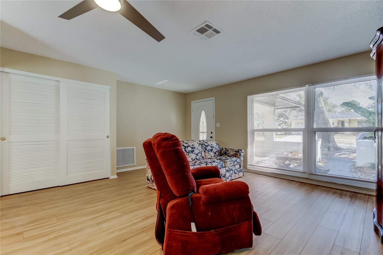 26. Front Living Room Area (14.10' x 17.7') Receives Natural Lighting from Double Windows, Nearly Floor to Ceiling Height!