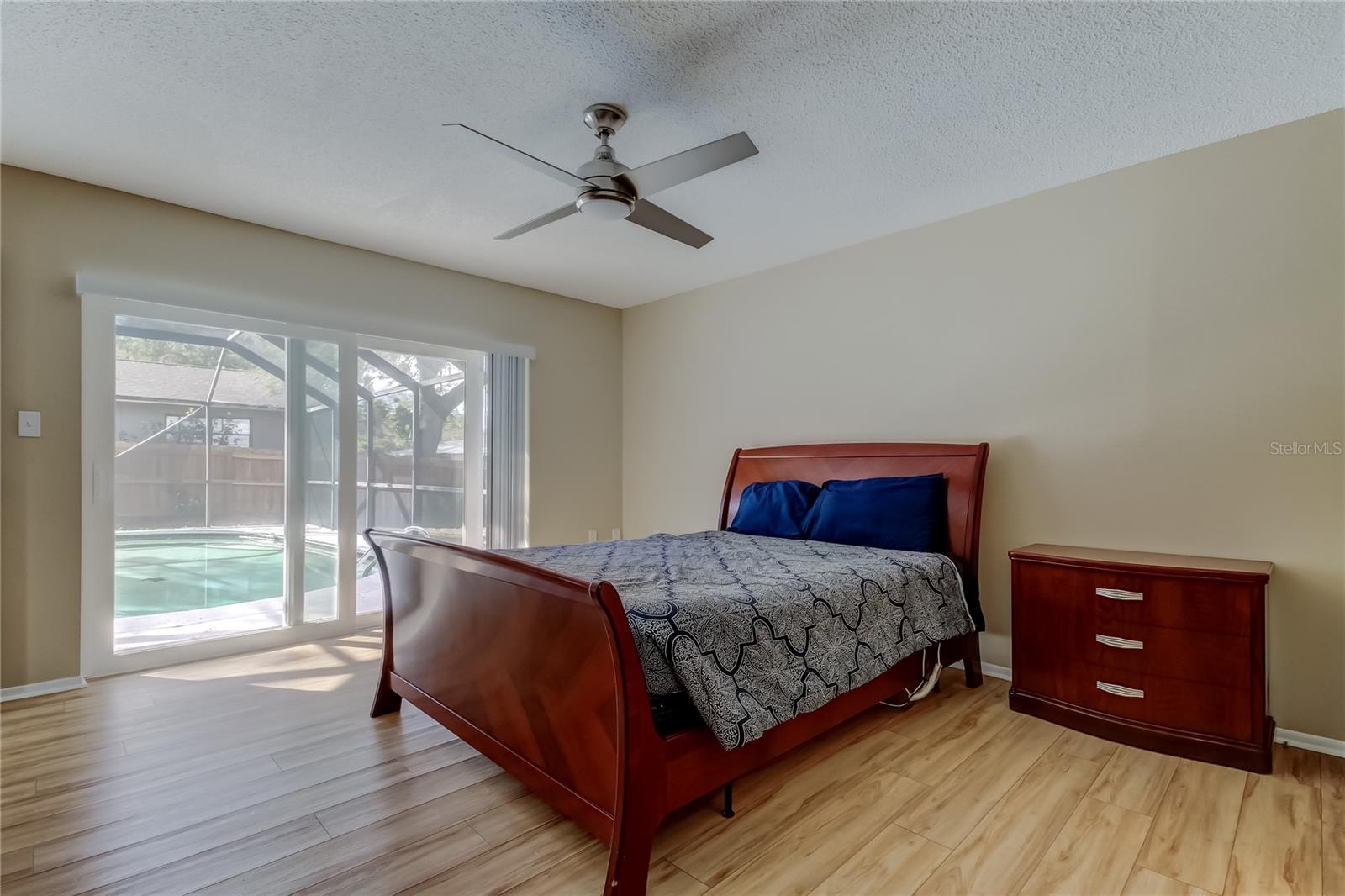 47. Primary Bedroom (14.5' x 13.10') Offers Full Ensuite Bathroom, Walk in Closet, Sliders to Pool Area!