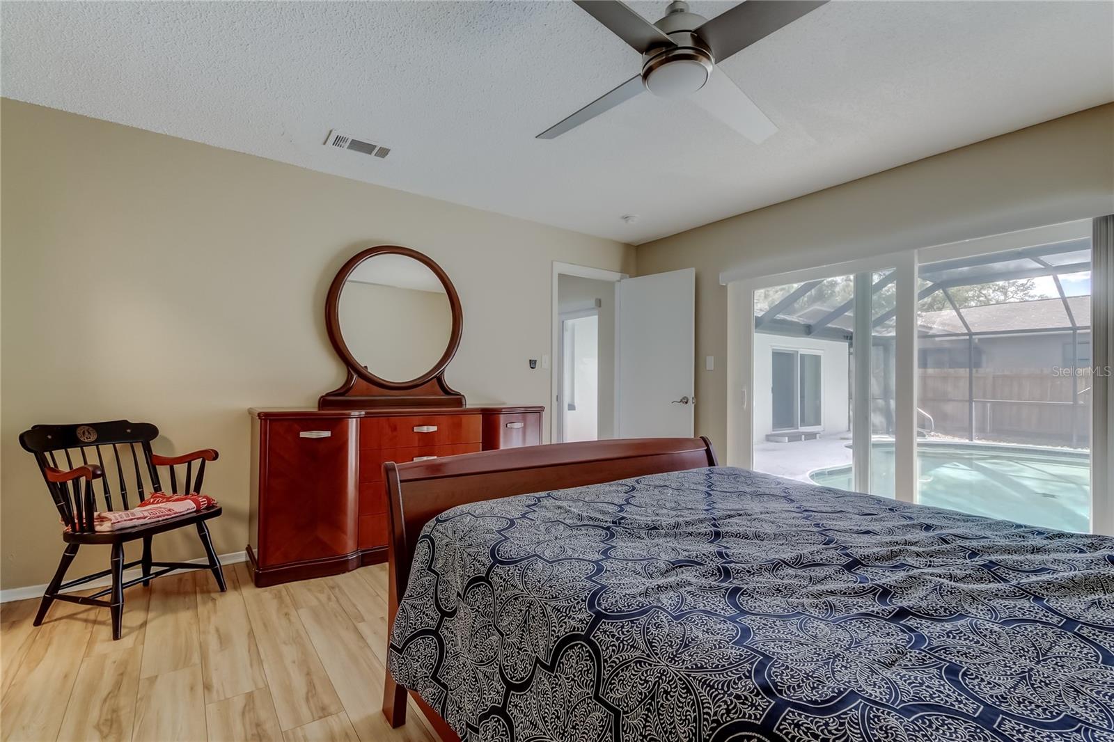 48. Primary Bedroom (14.5' x 13.10') Offers Full Ensuite Bathroom, Walk in Closet, Sliders to Pool Area!