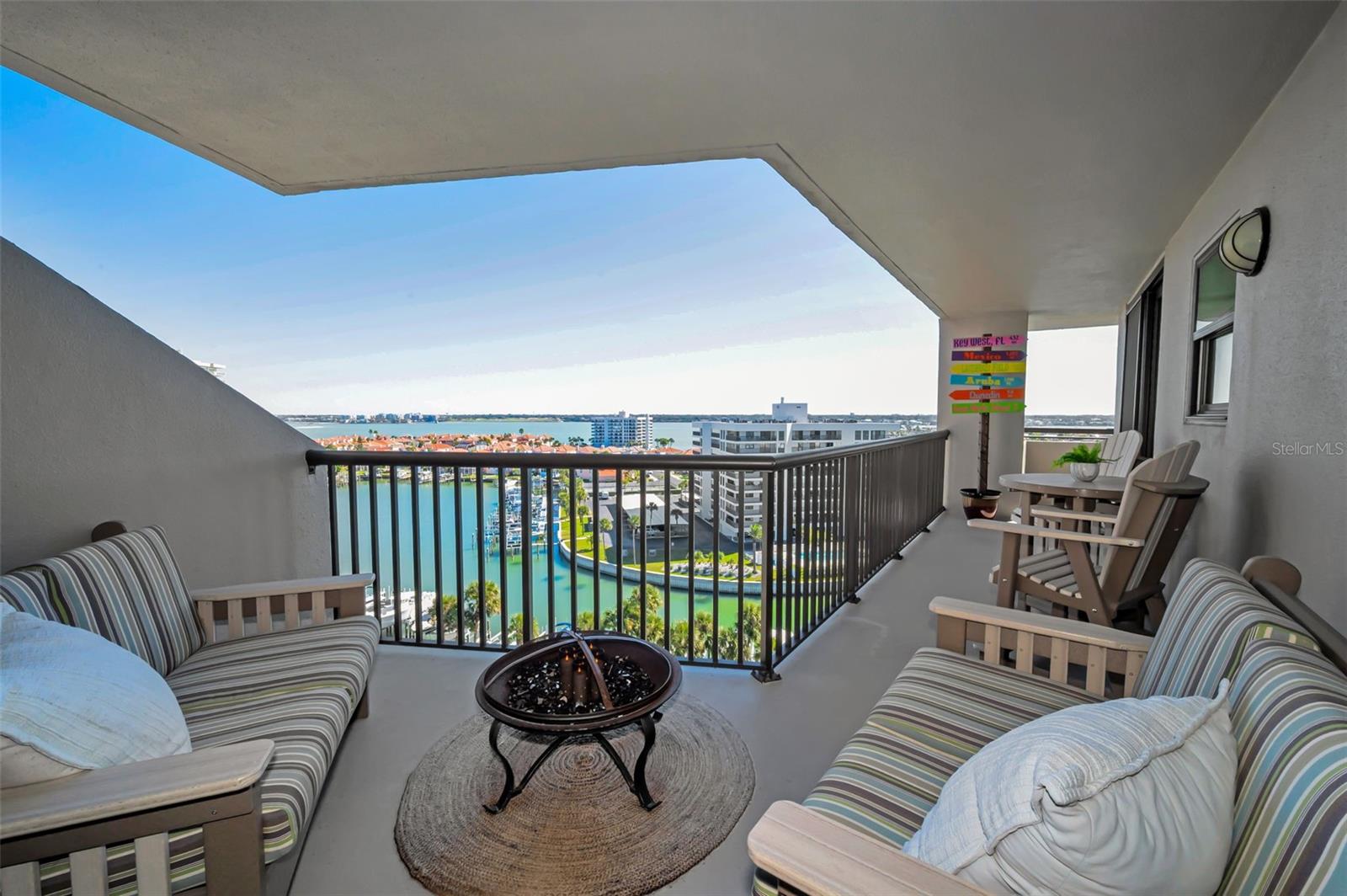 An expansive wraparound balcony extending from the living room to the Primary bedroom with uninterrupted waterfront vistas!