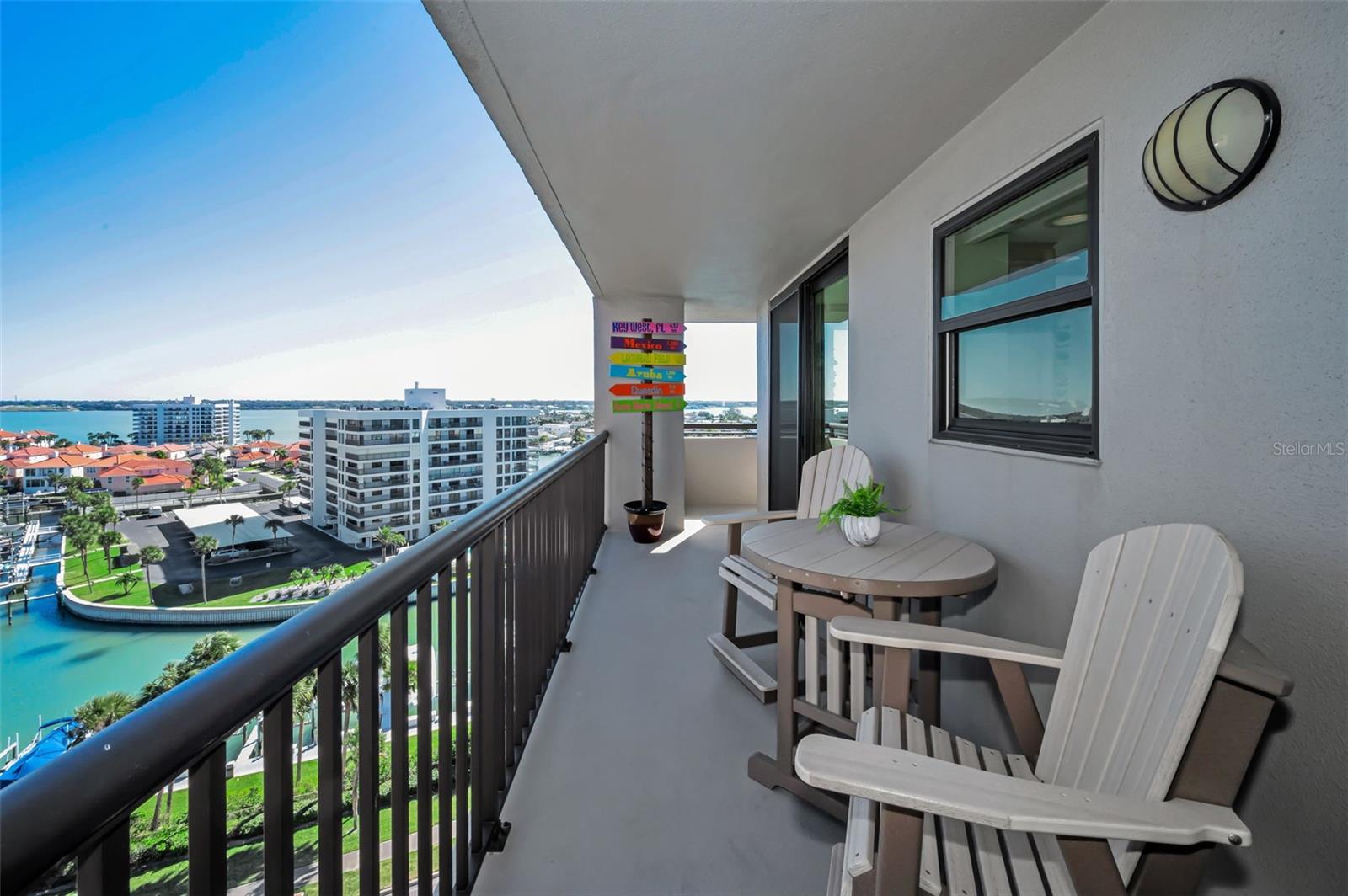 A sweeping wraparound balcony off the main living space capturing breathtaking, wide-angle water views