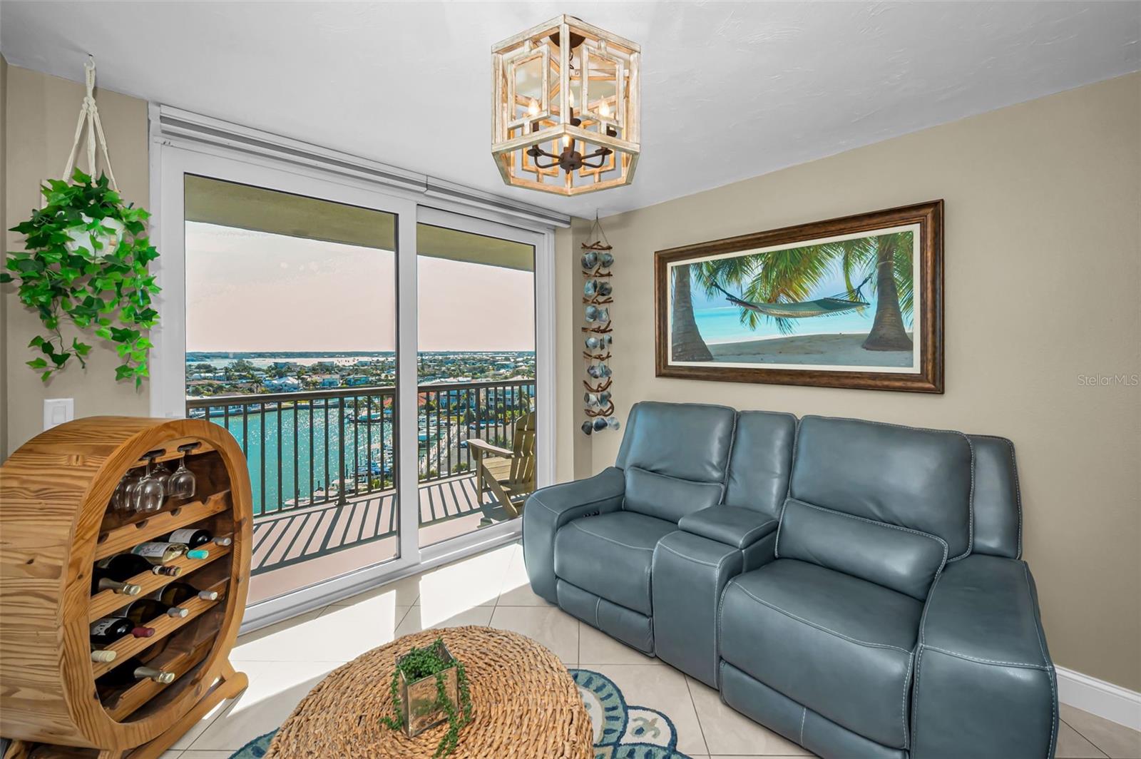 Sun-filled flex room—ideal as a family-sized dining area—offering panoramic waterfront views