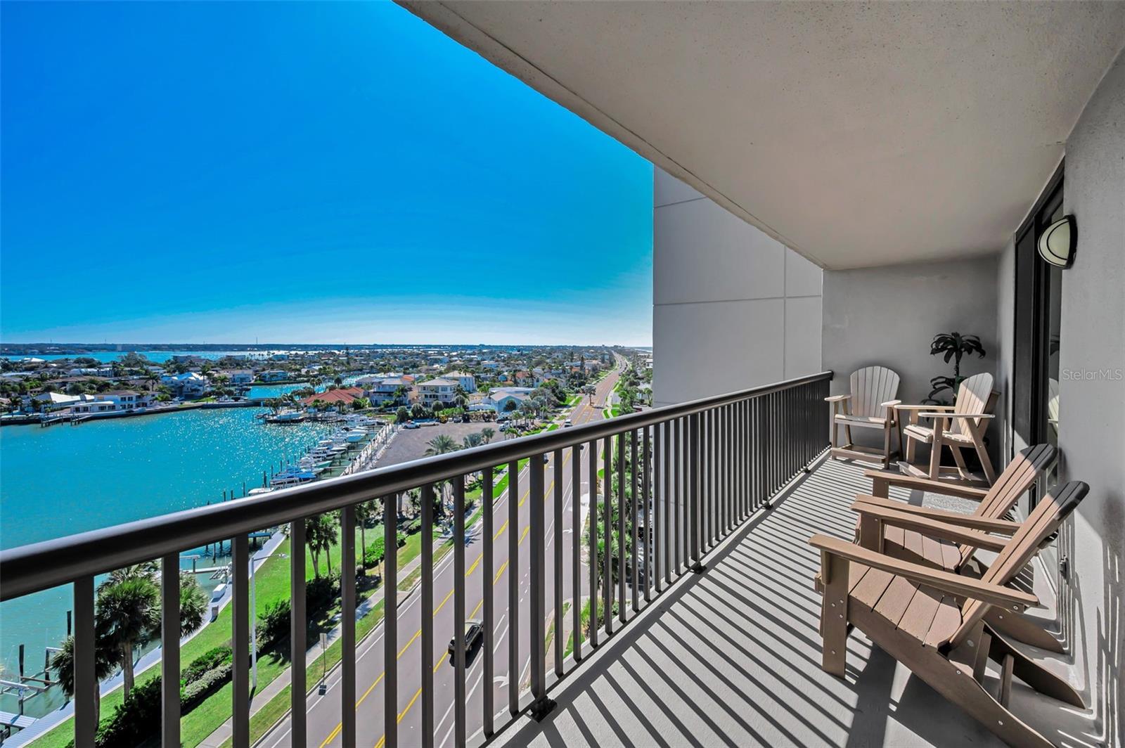 Spacious wraparound balcony off the Primary bedroom showcasing panoramic water views