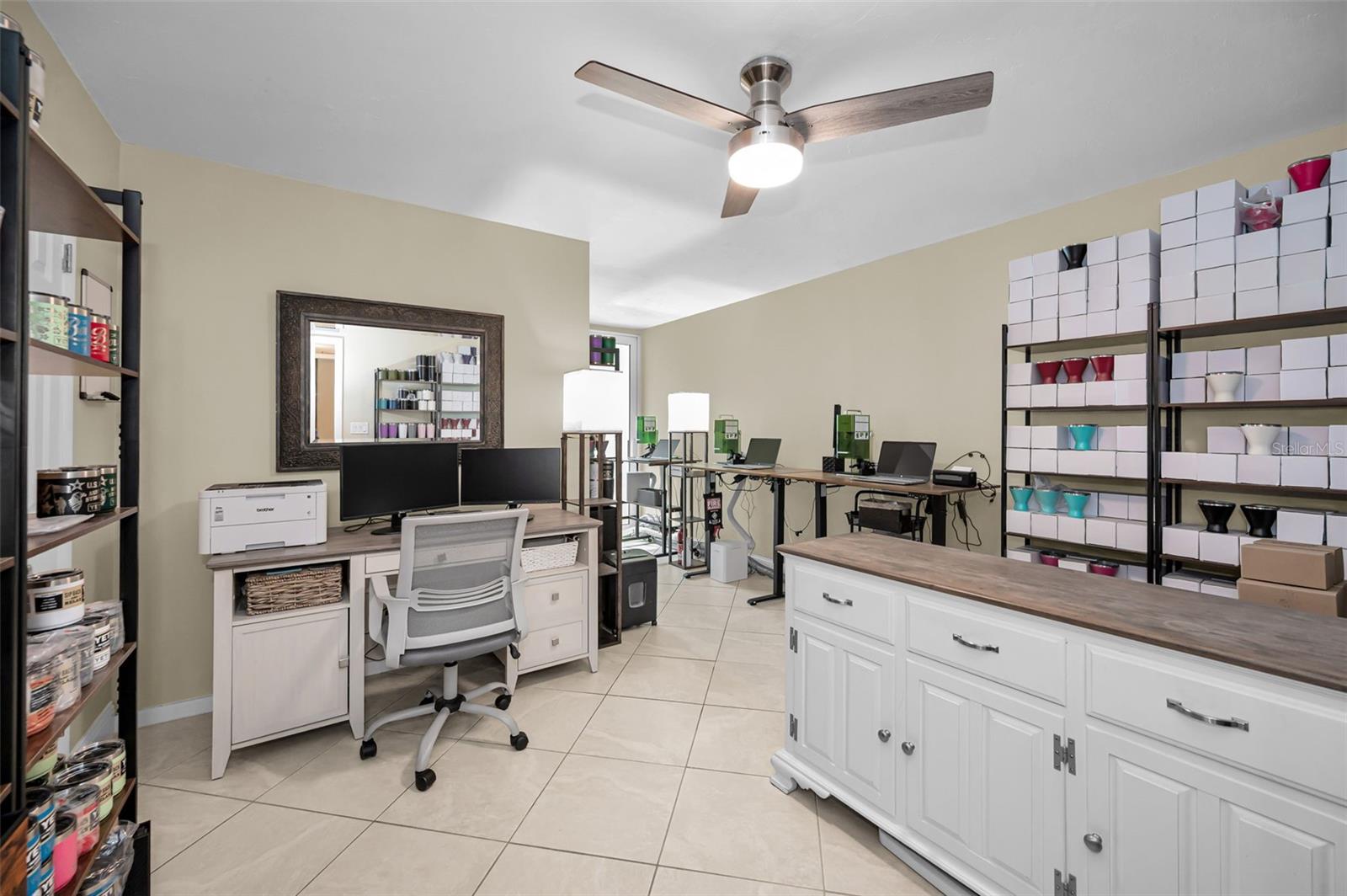 Second bedroom, currently styled as a work-from-home office, positioned on the opposite side of the residence off the entry