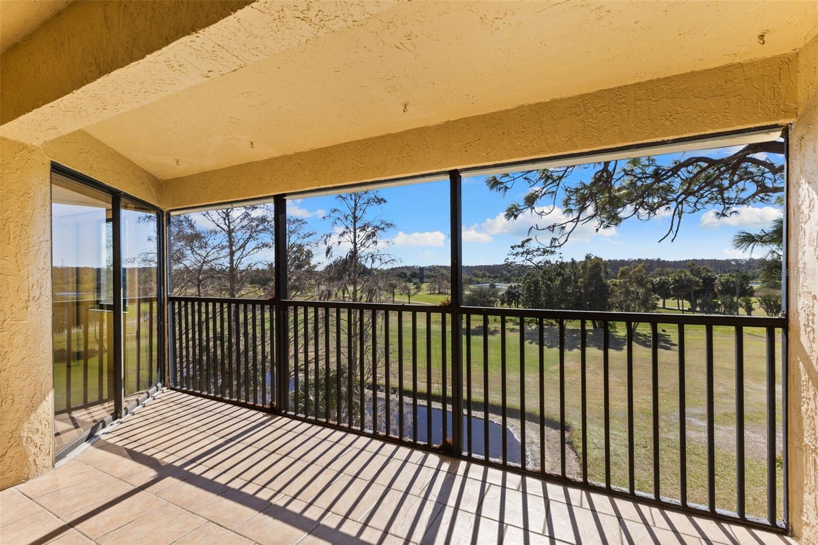 Covered Screen Lanai Overlooking Golf Course , Pond and Lake in the Distance