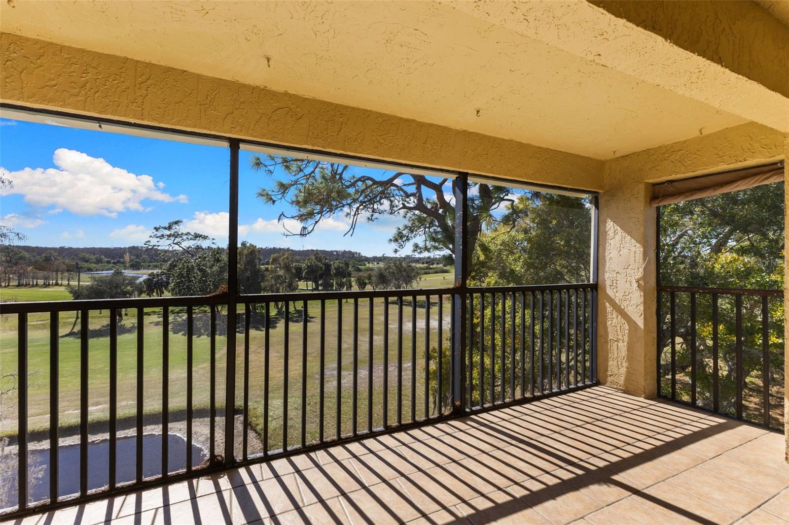 Covered Screen Lanai Overlooking Golf Course , Pond and Lake in the Distance