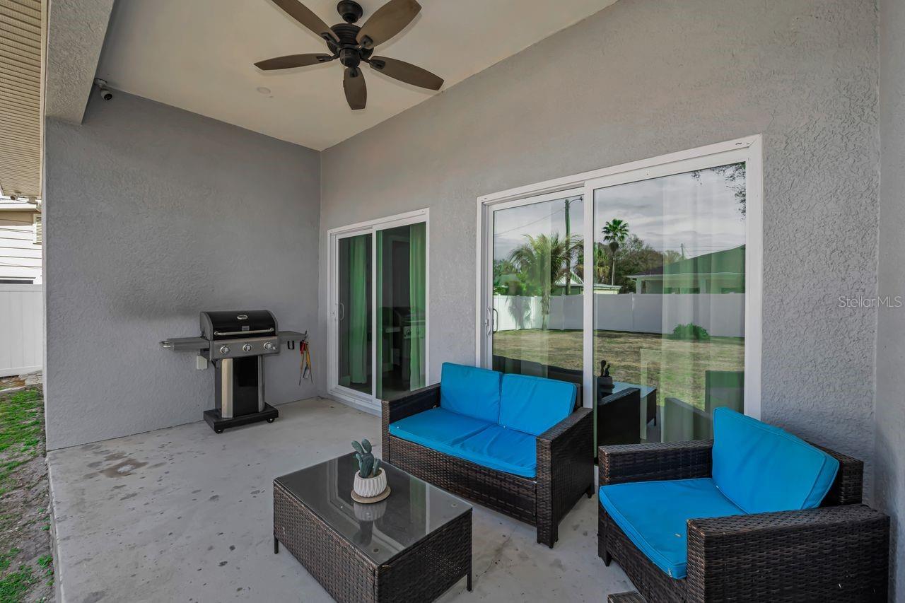 This covered patio with outdoor fan makes for a quiet retreat