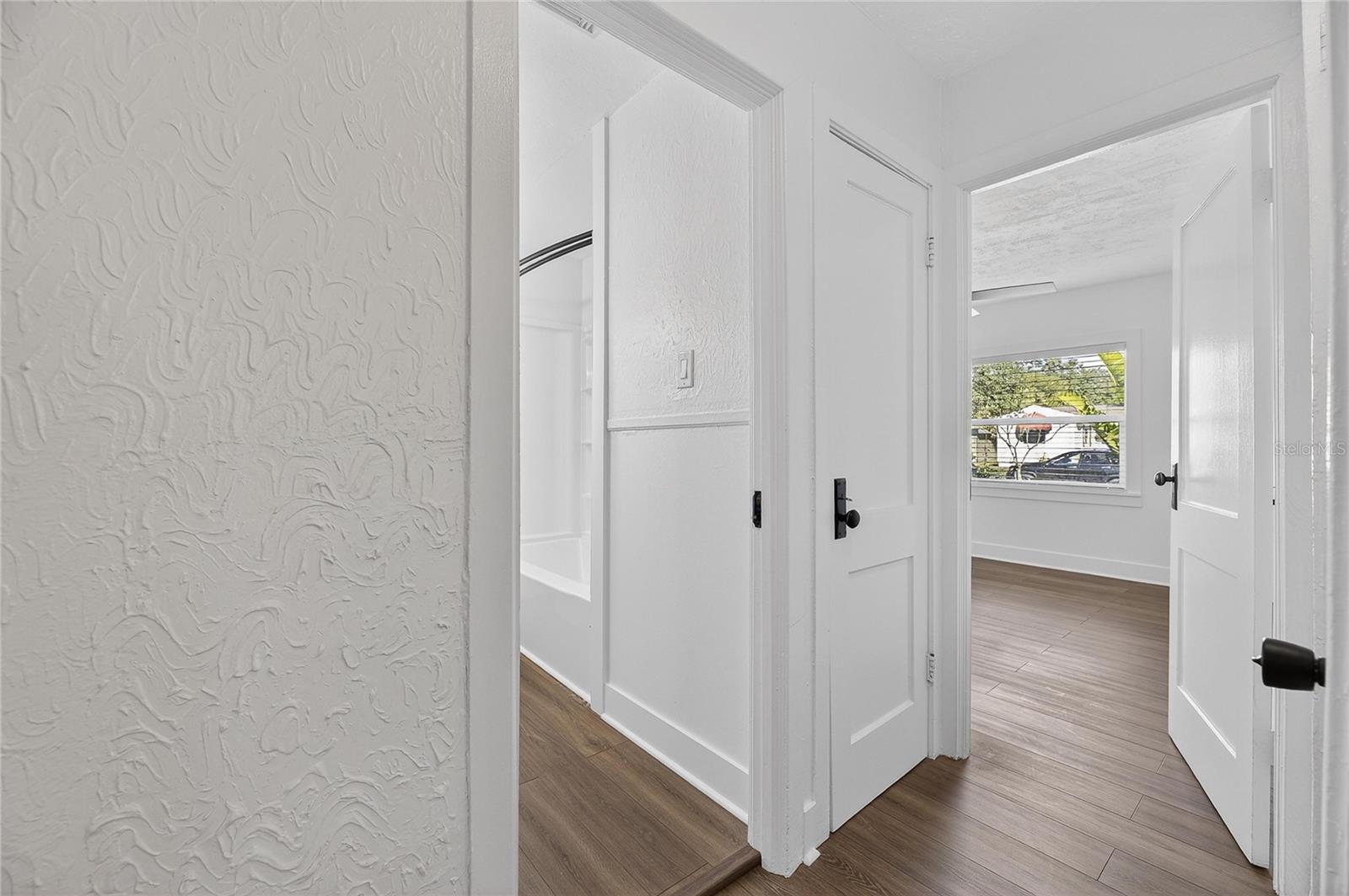 Hallway into other baths and rooms