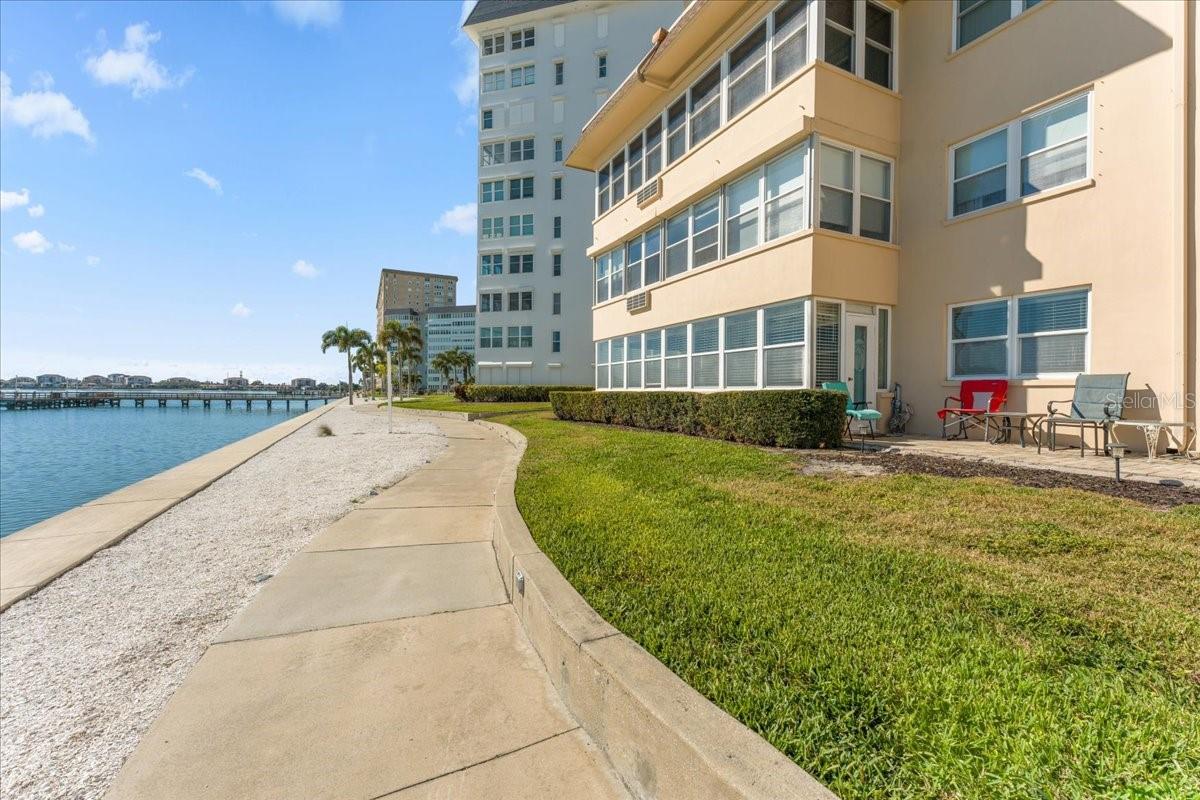 Lush landscaping lines  the waterfront walking path.