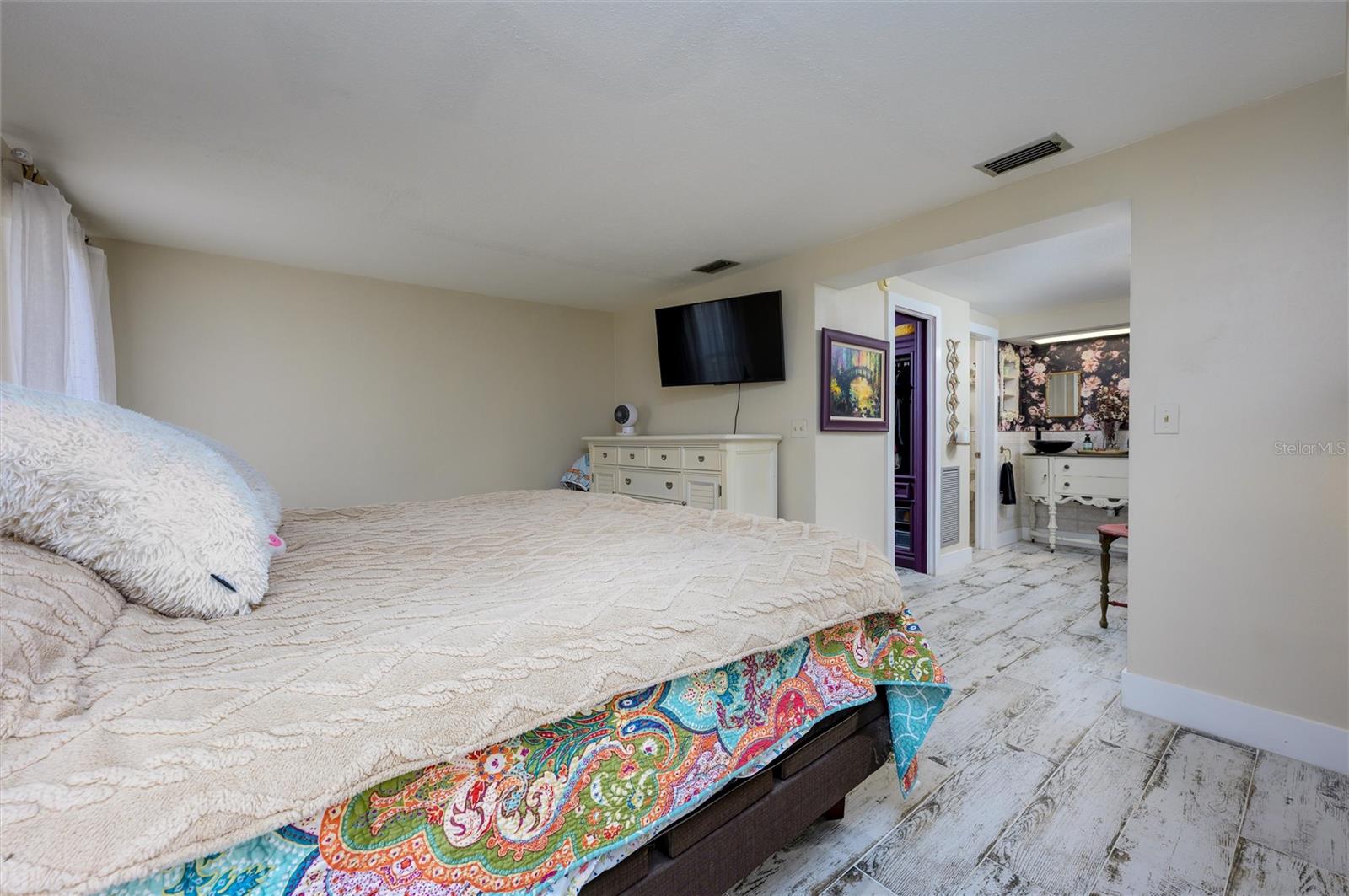 Primary Bedroom showing hall leading to closet and vanity