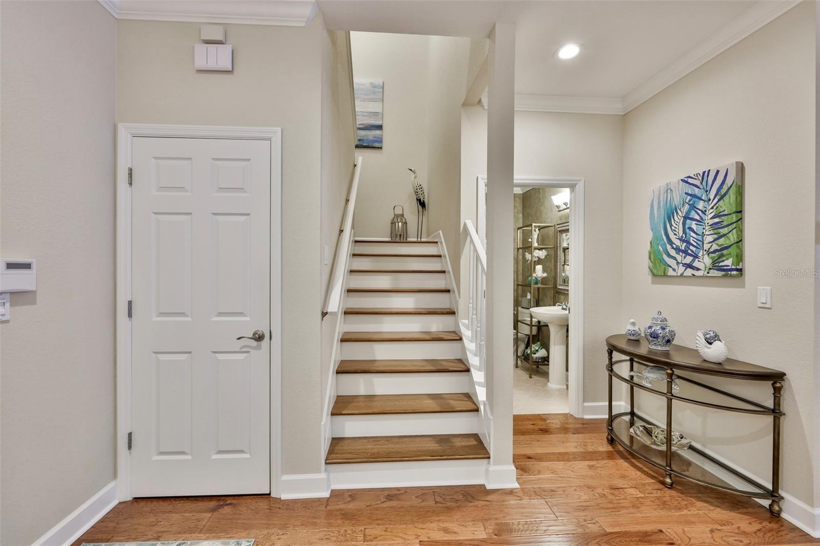 Beautiful Engineered Wood Floors Continuing up the stairway. Large Storage Closet Under Stairway.