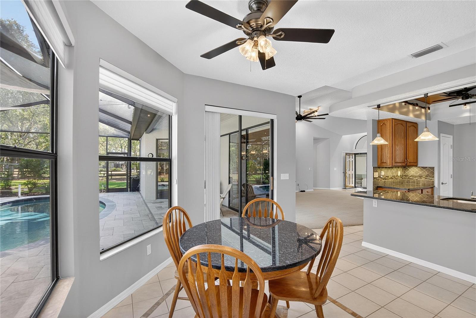 Breakfast area with customgranite breakfast table conveys