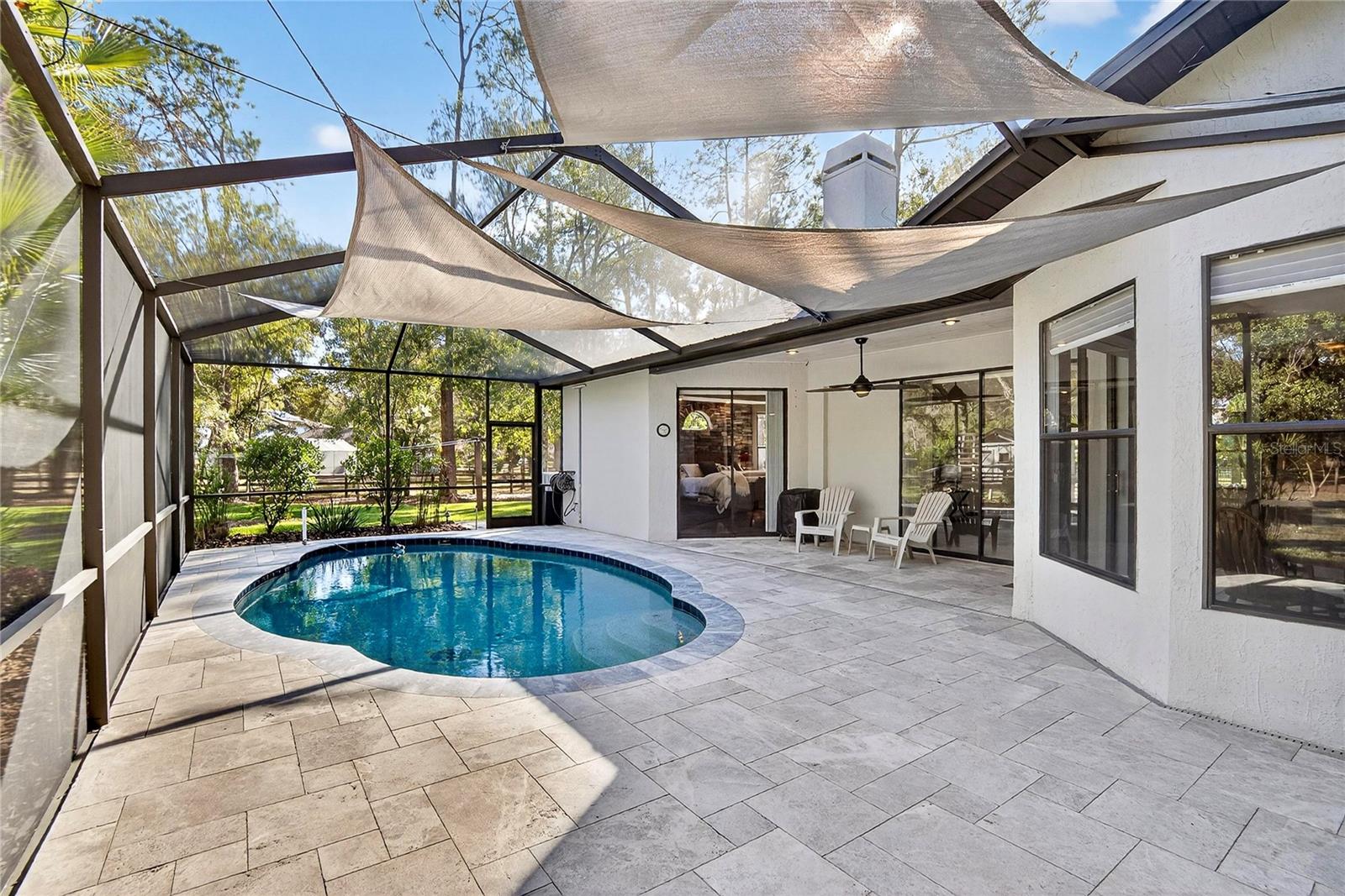 Newly remodeled pool and patio with leathered marble pavers.