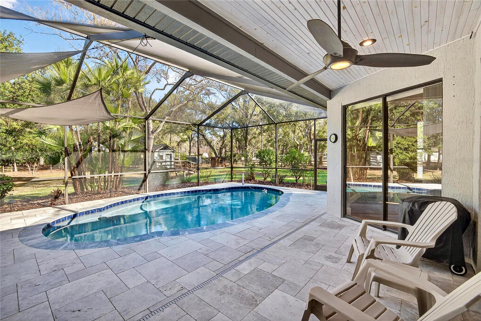 Newly remodeled pool and patio with leathered marble pavers.