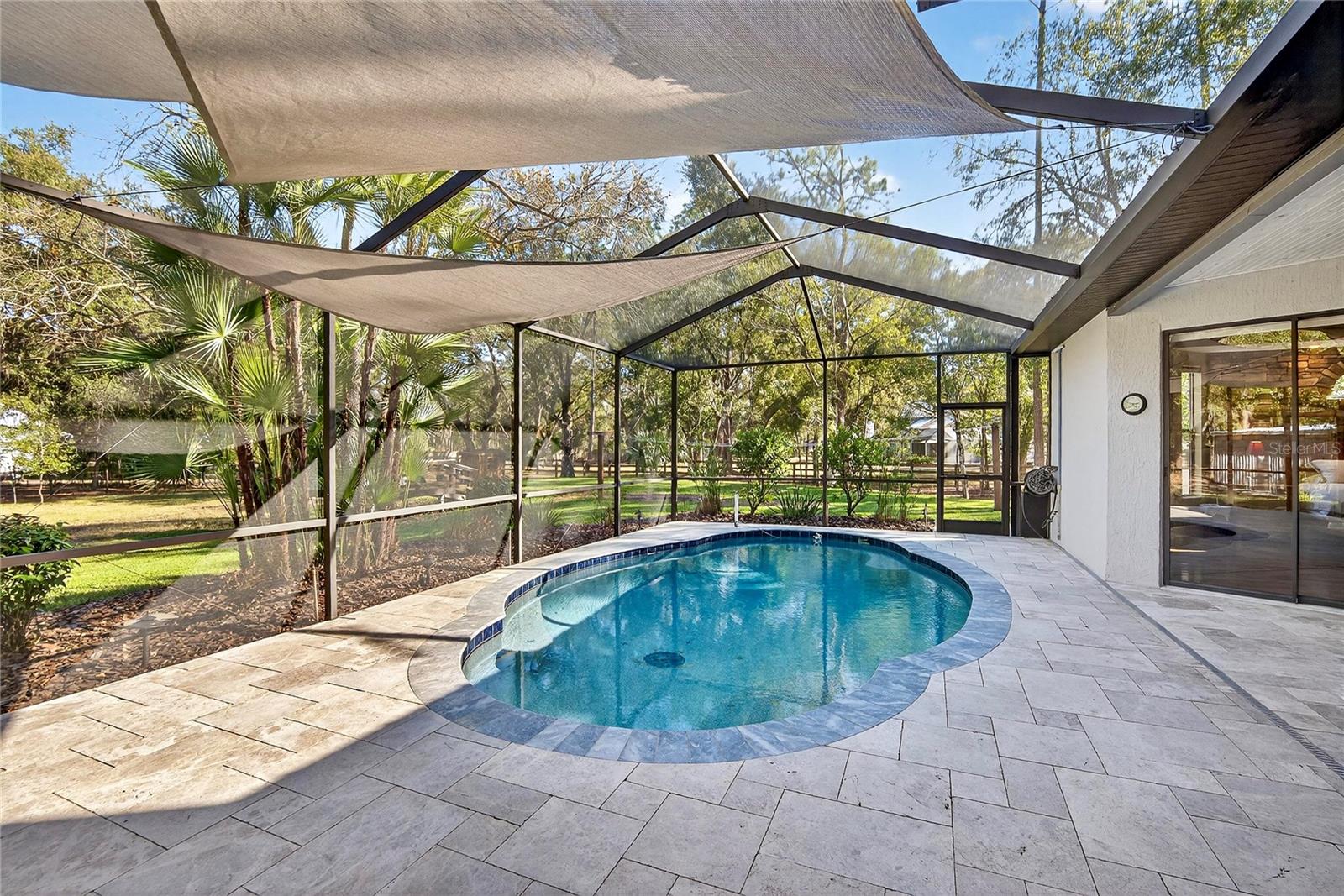 Newly remodeled pool and patio with leathered marble pavers.