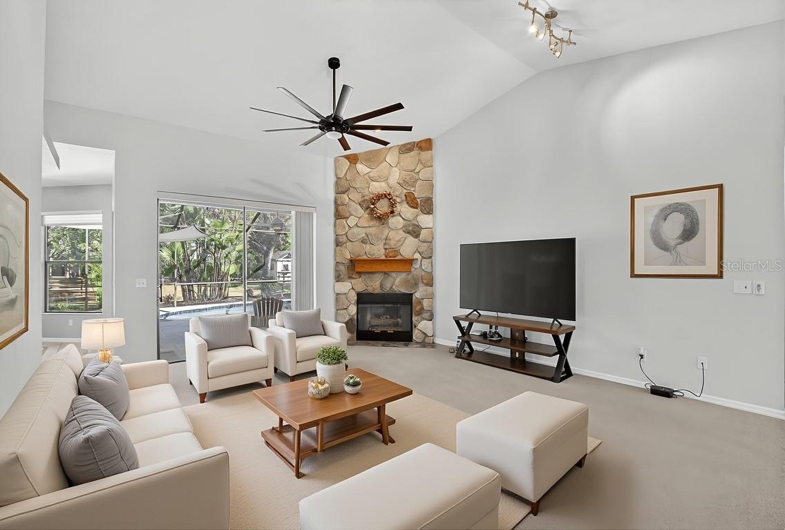 living room with fieldstone gas fireplace