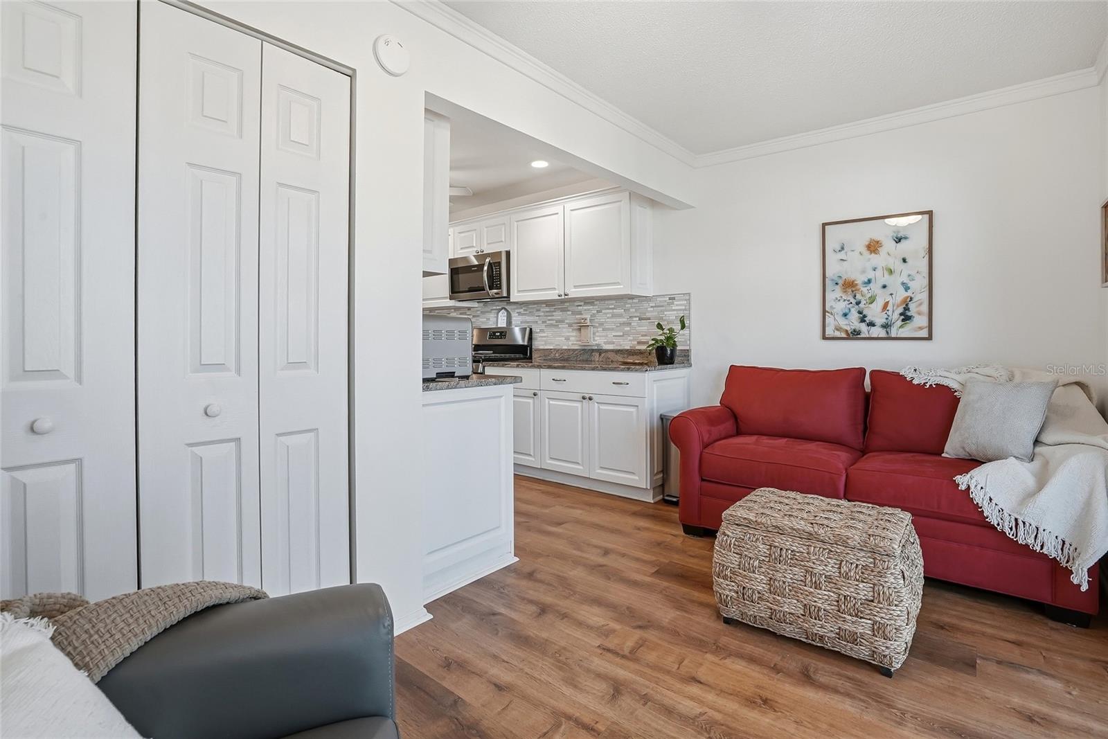 Laundry closet discreetly hidden behind the closed doors.