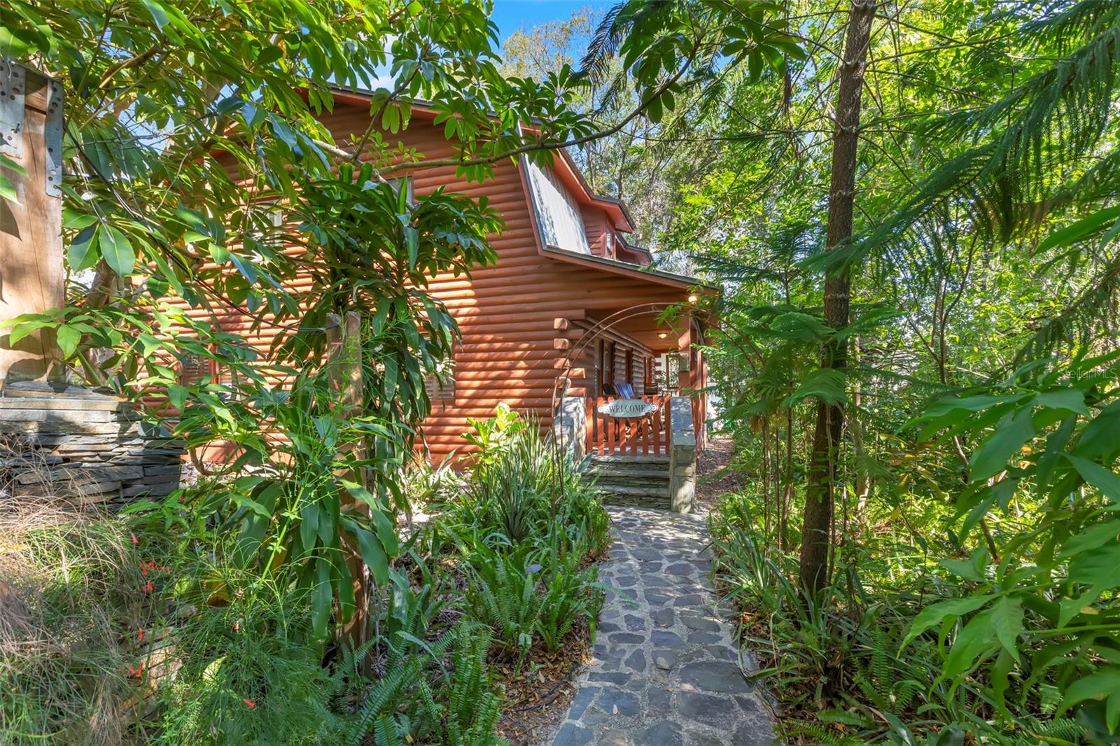 The home’s natural privacy, mature canopy trees,  seamlessly blend into its wooded setting.