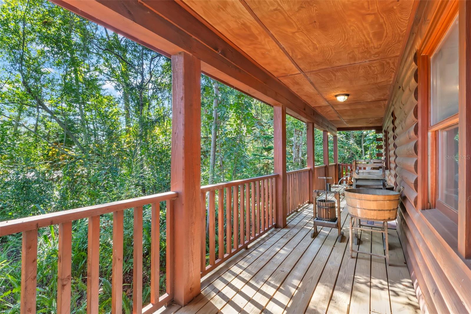 Hard to believe this hidden gem is close to everything! Beautiful handcrafted log siding, natural light, and a peaceful outdoor retreat feel.