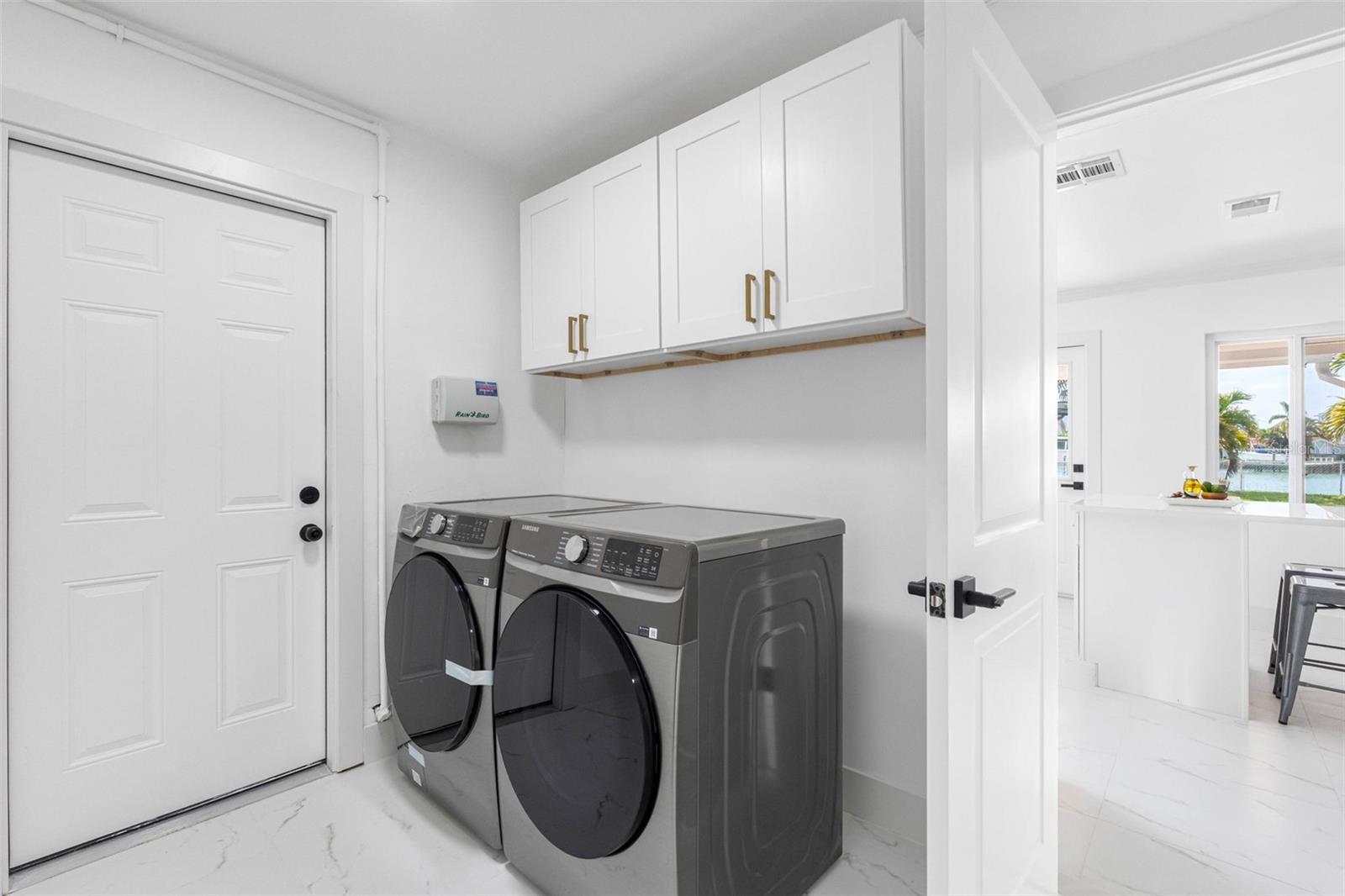 Laundry room, with storage, connects to the kitchen.