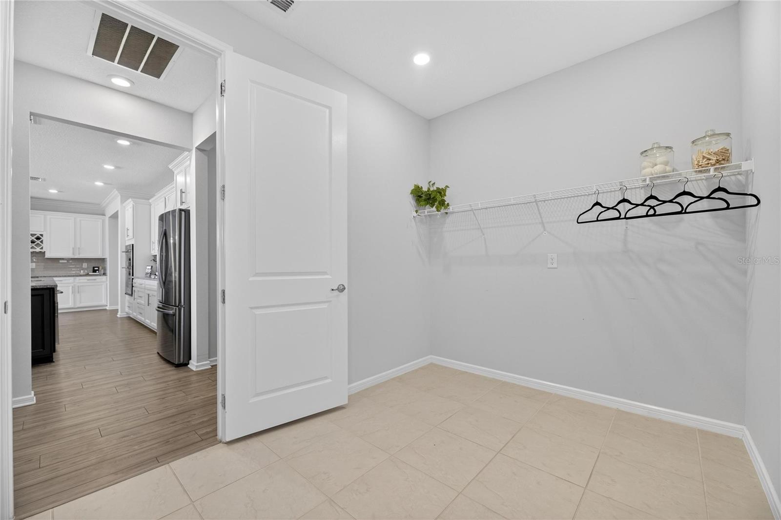 Laundry room with hanging clothes area