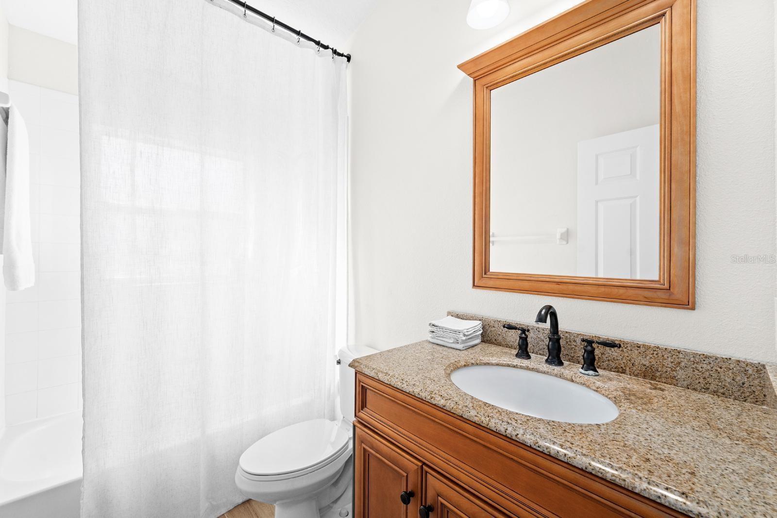 The second bathroom is light and bright and has a tub/shower combo.