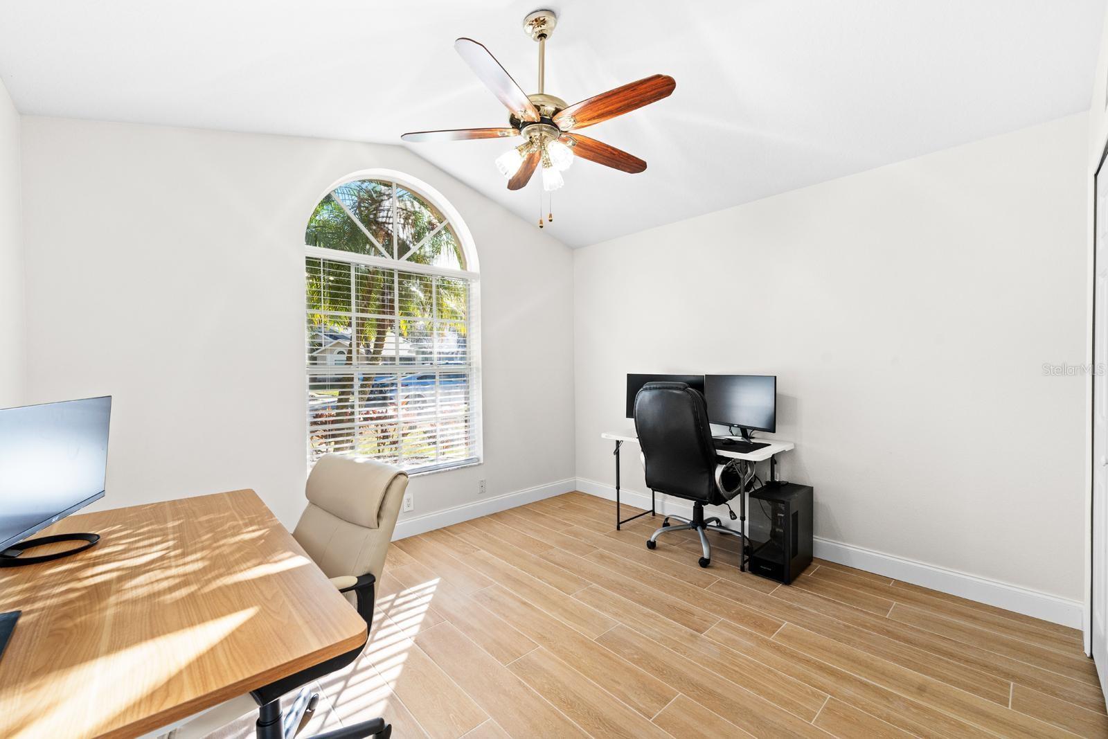 The third bedroom features the same plank tile flooring, a lighted ceiling fan, and a spacious closet!