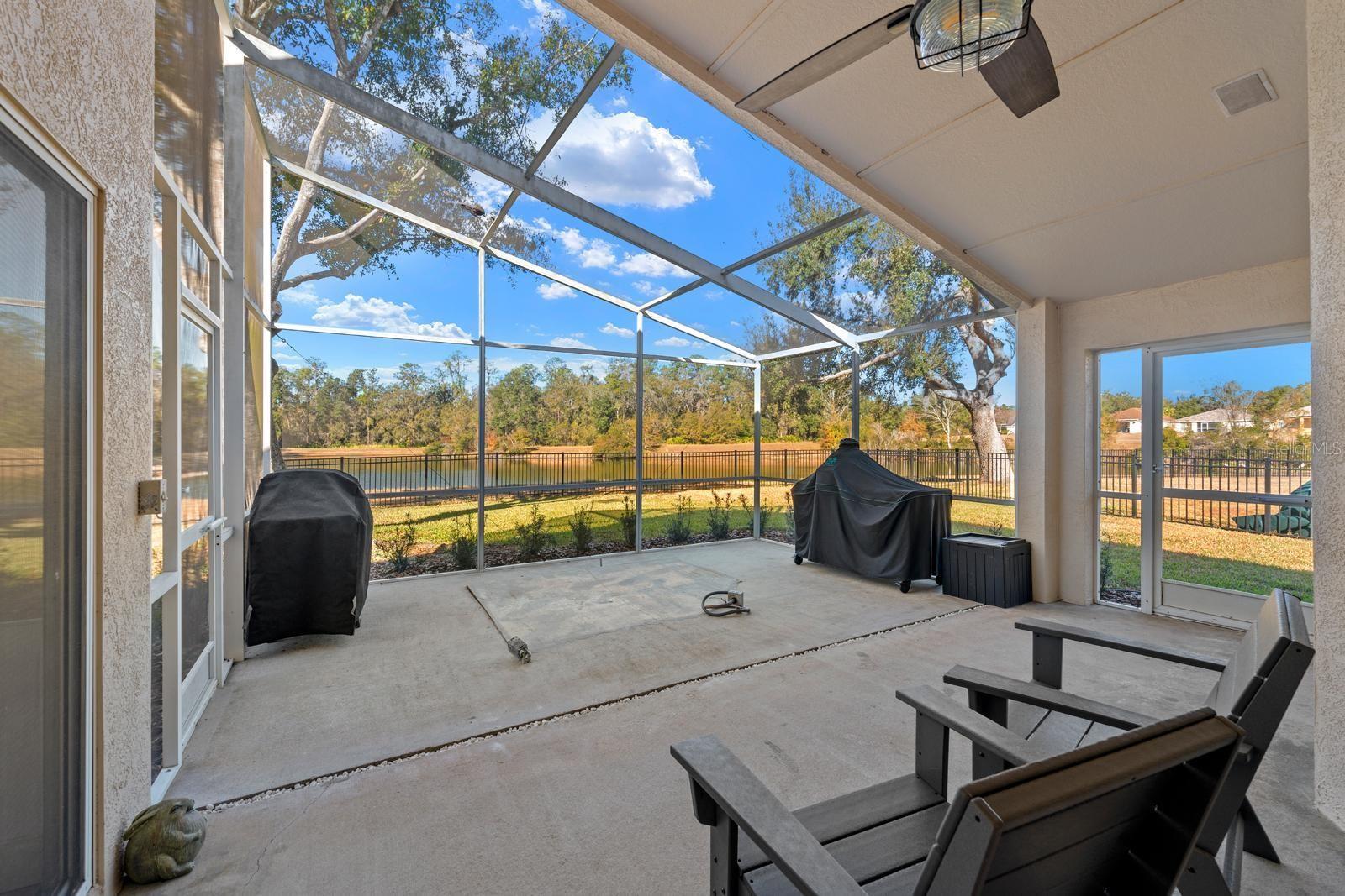The screened-in porch is very large and has 2 screen doors and a ceiling fan.  There's a gas connection in the slab which can be utilized for a spa or an outdoor kitchen....or capped off and buried.  There's also a narrow rock filled drain so rain water can drain properly.