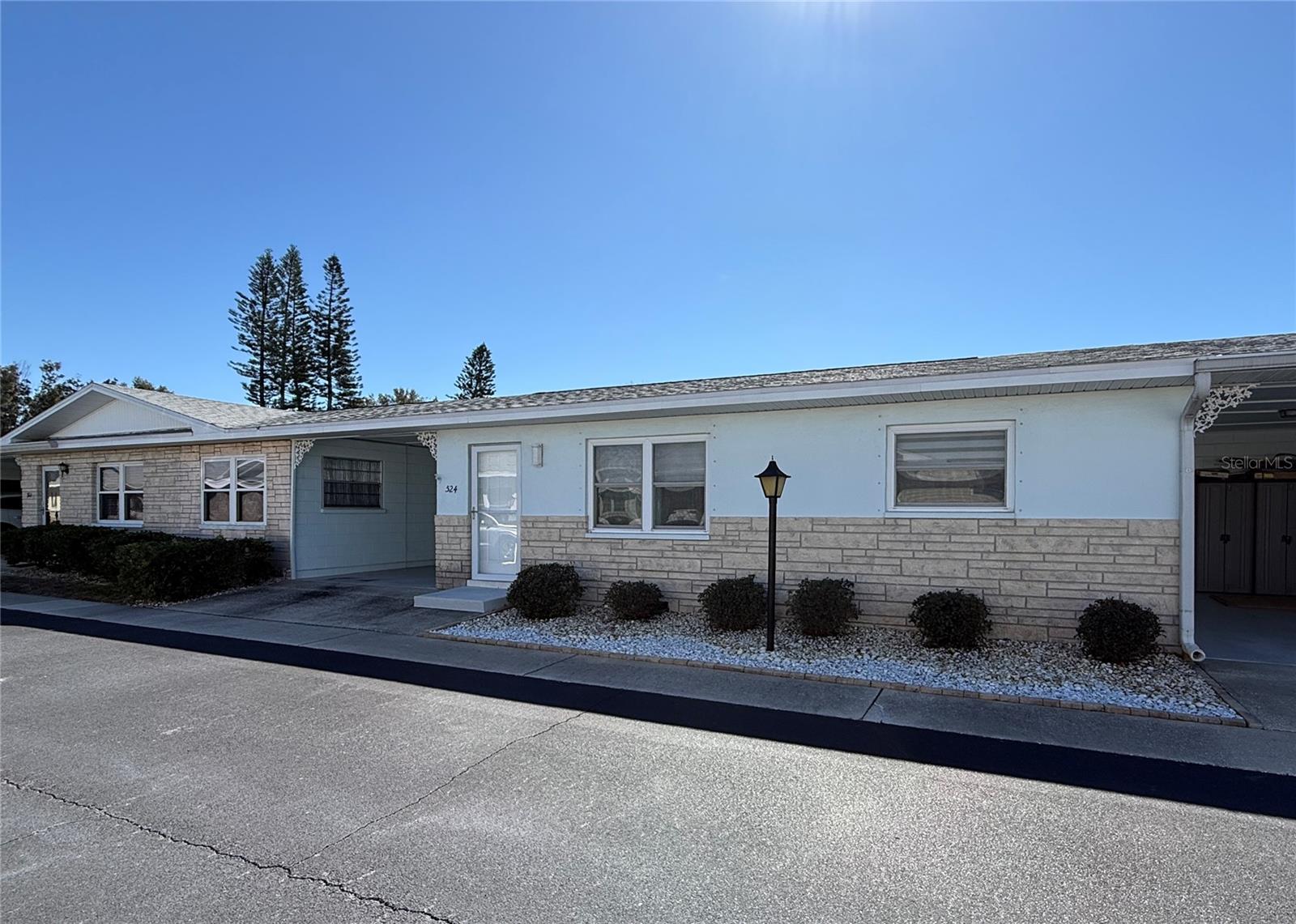 Front of the Block Construction villa with attached carport. The living space has no shared interior walls with neighbors.