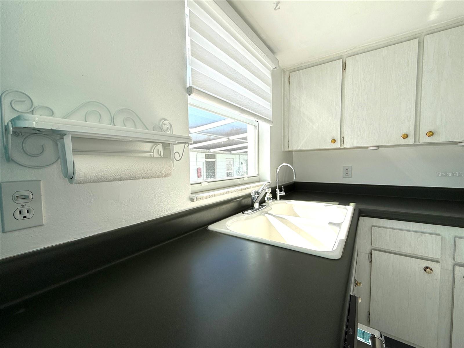 Double kitchen sink with filtered water.  Newer double pane window and premium shade