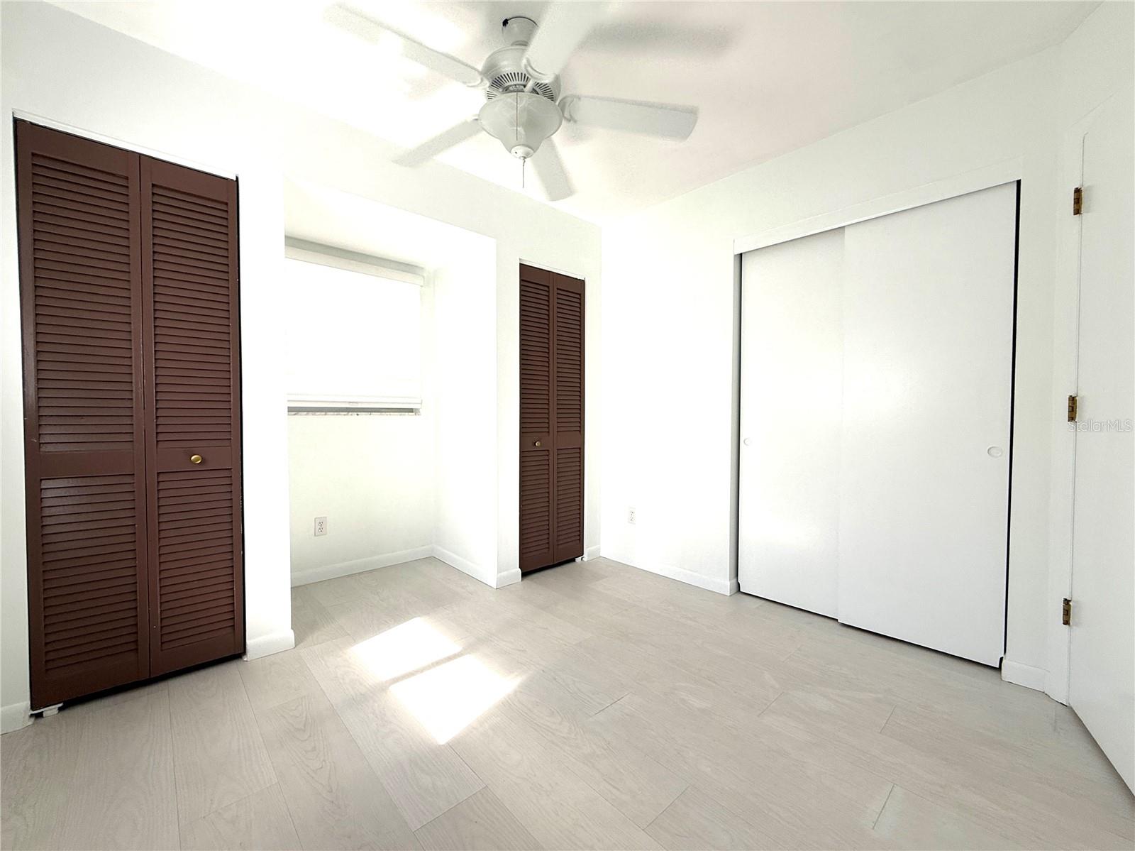 This bedroom features 3 closets!