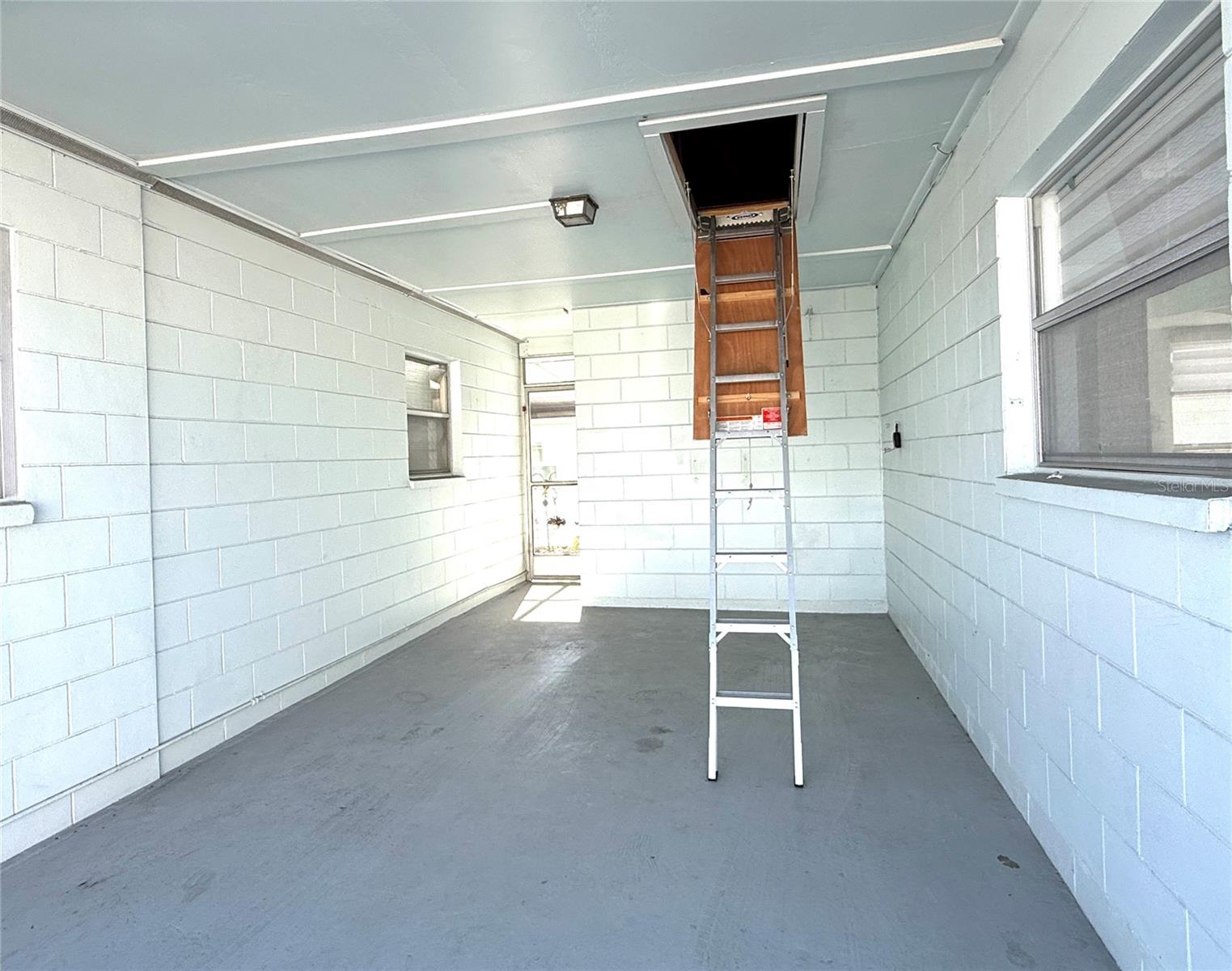 The oversized attached carport offers additional storage in the attic via the newer fold down stairs.
