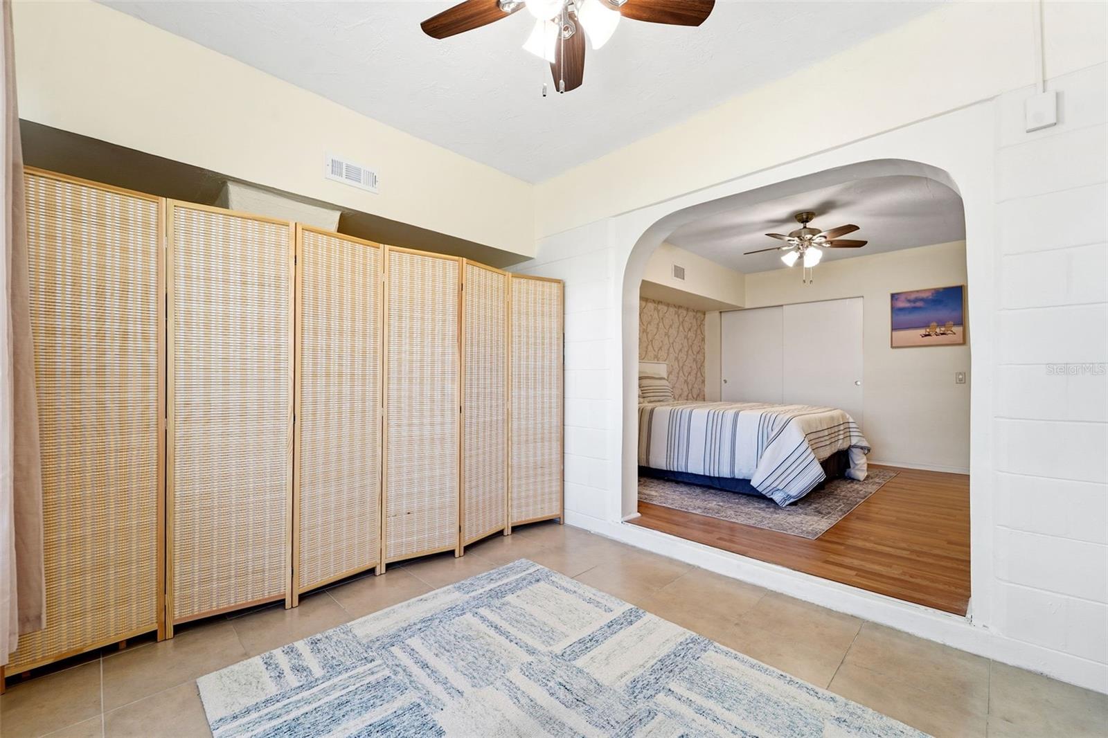 The Florida room enhances the home with versatile living space ideal for a TV room, hobby area, or home office, overlooking a lush, landscaped courtyard.