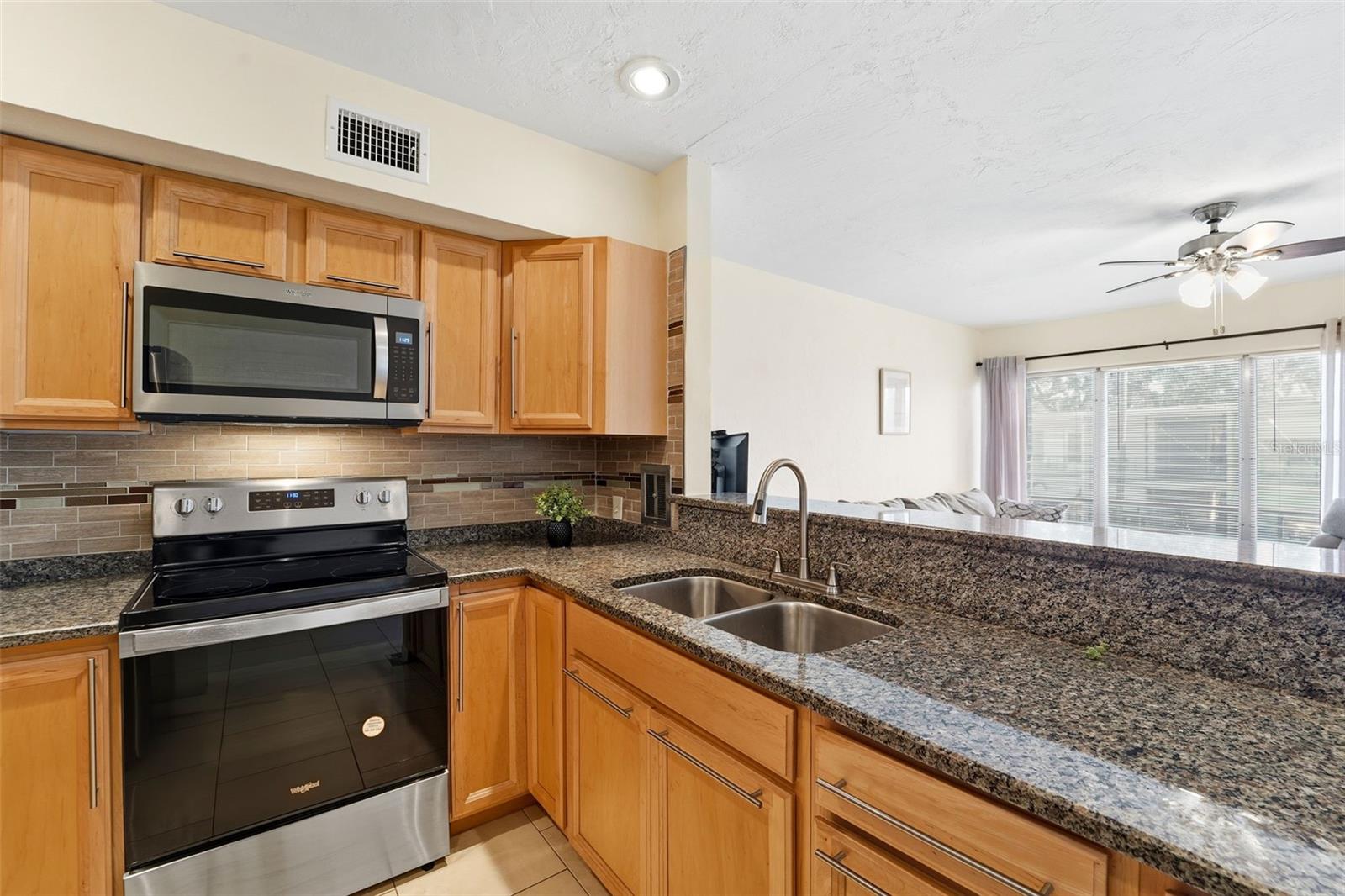 Granite countertops, abundant storage, and stainless steel appliances come together in a kitchen you’ll love.