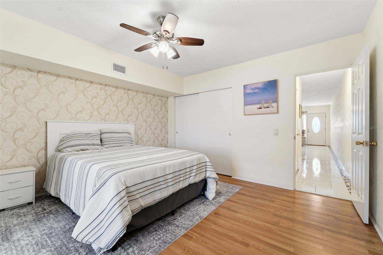 The oversized bedroom easily accommodates additional dressers and includes overhead lighting and a ceiling fan for added comfort.