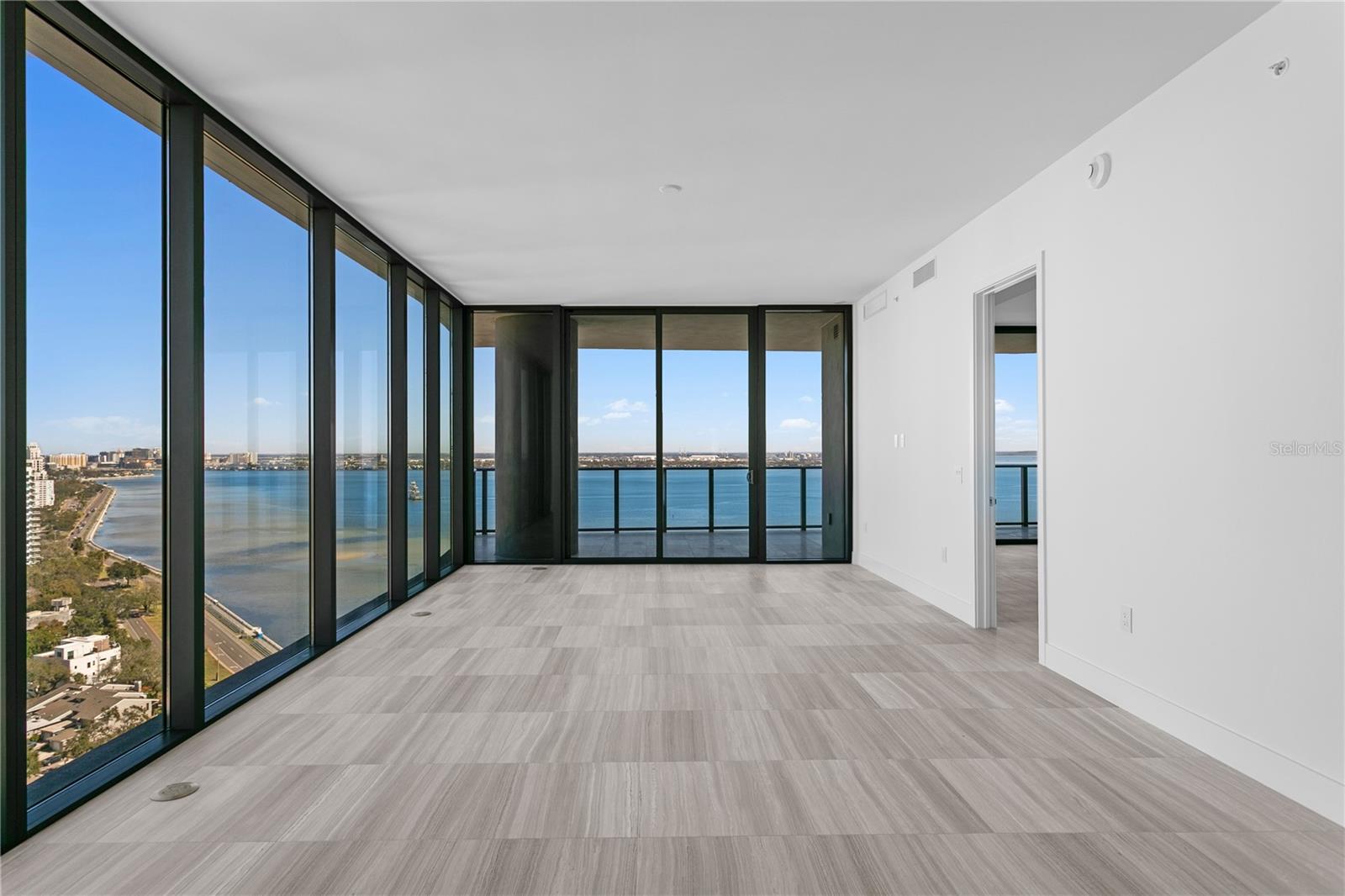 Floor-to-ceiling windows offering breathtaking bay views