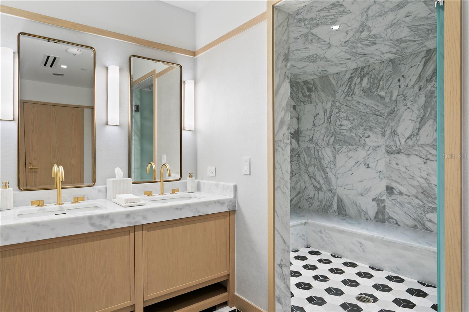 Men’s and women’s fitness locker room vanity areas with premium finishes