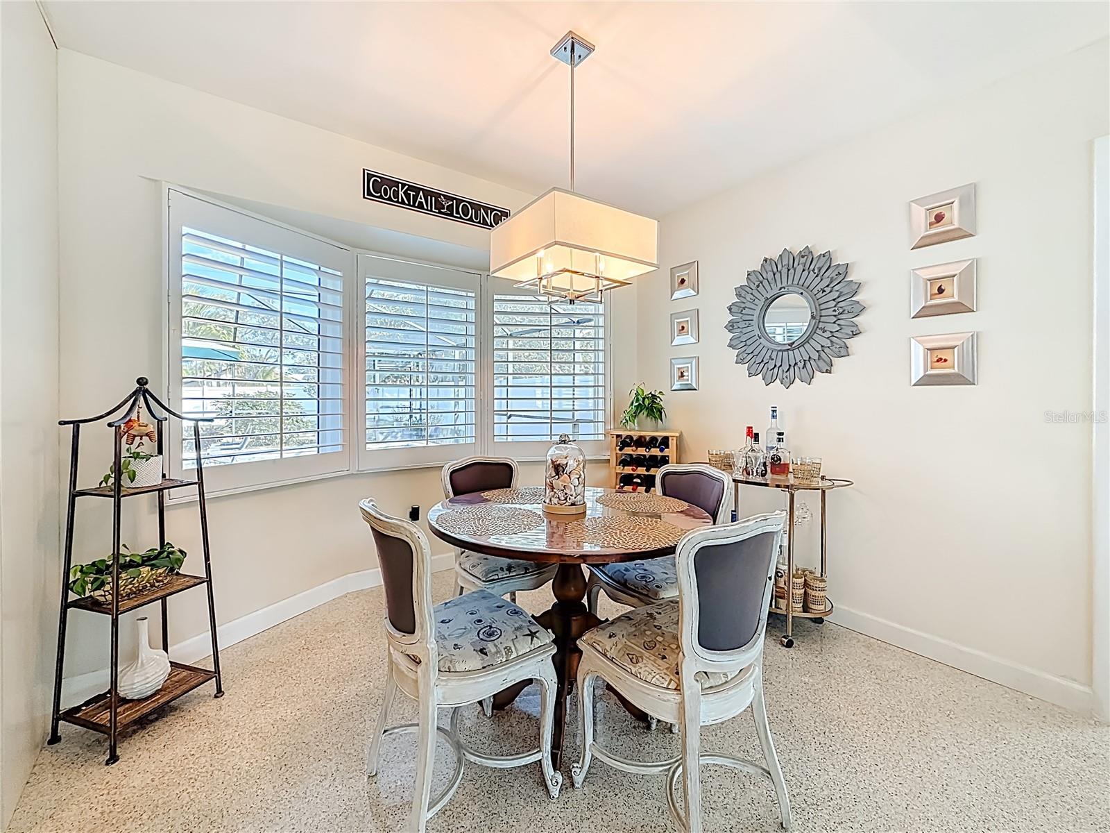 The kitchen nook looks out to the beautiful pool area.