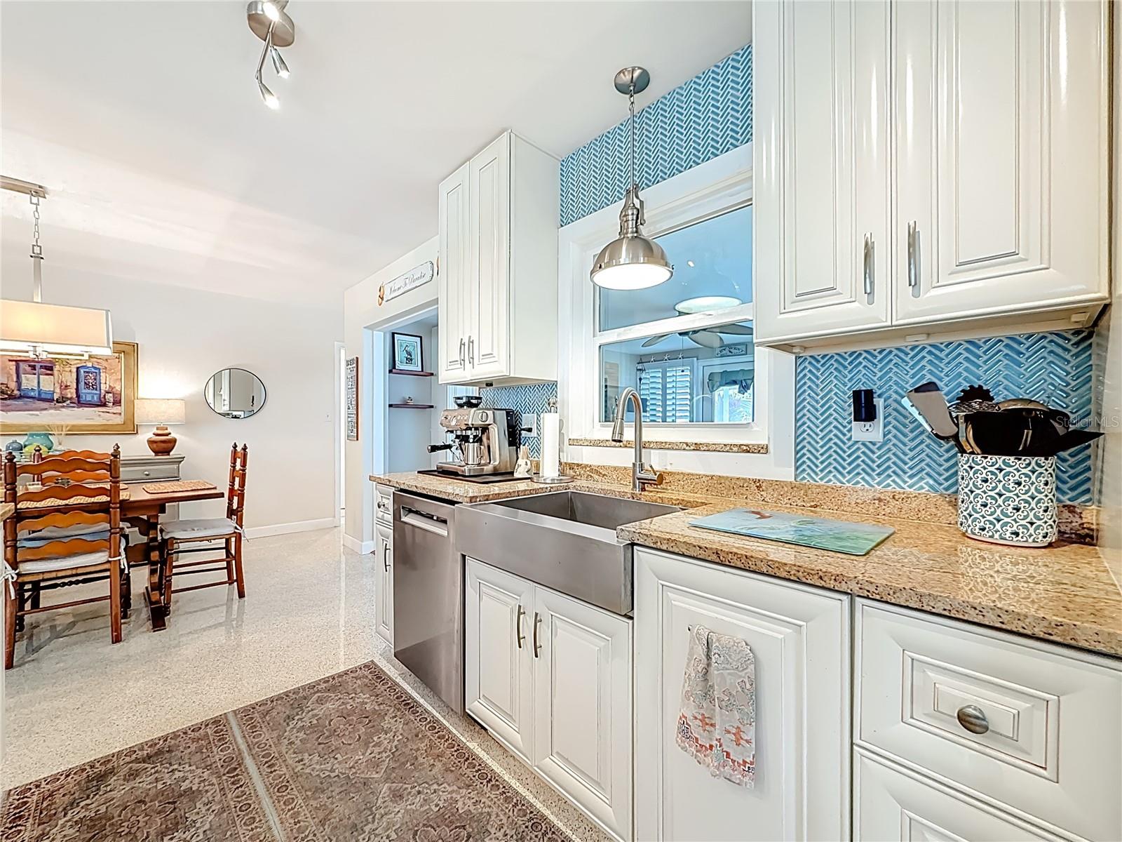 The kitchen looks into the bonus Florida Room.
