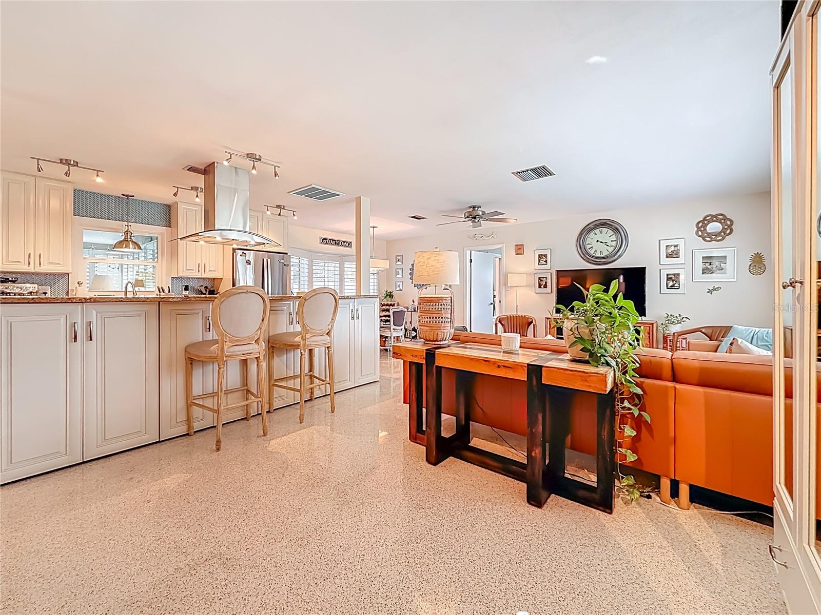 Upon entry, looking into the living room, you can see the primary bedroom door to the right.