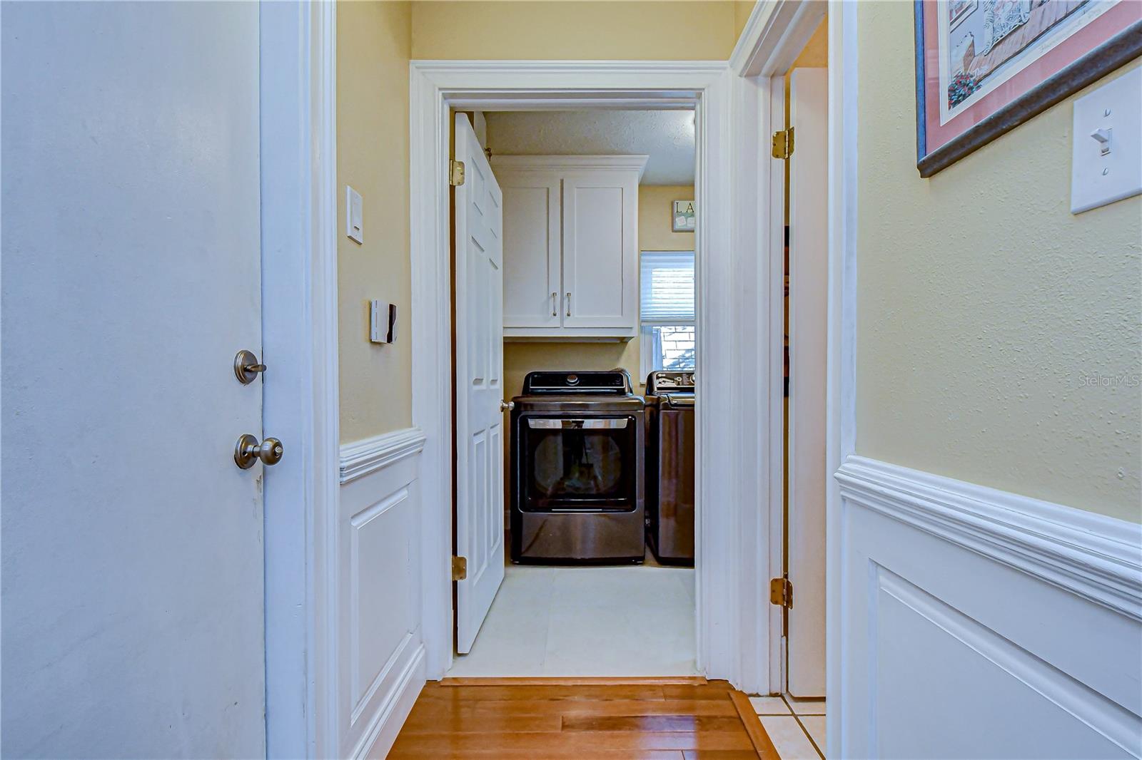 Hallway to garage, laundry room, and half bath.