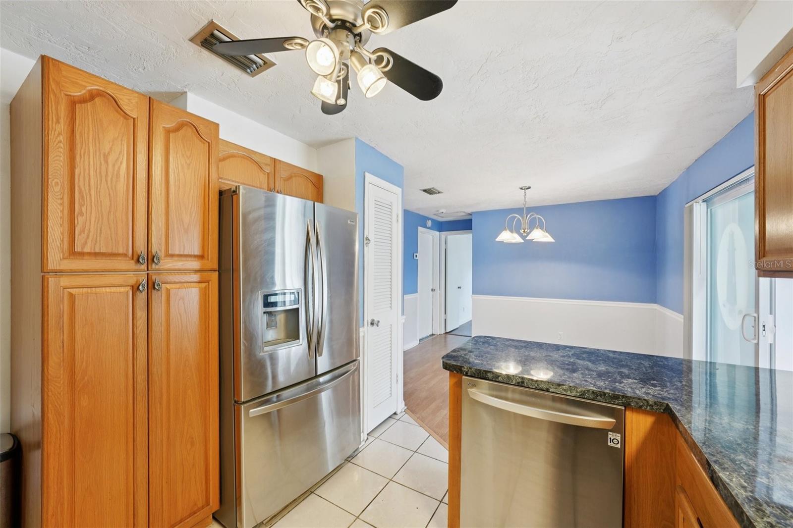 Kitchen with stainless steel appliances, granite countertops, pantry and window over sink