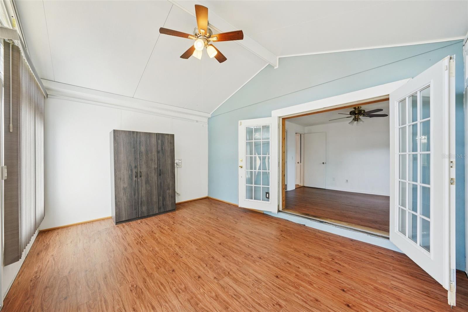 Unfinished Bonus room with vaulted ceiling, French doors from bedroom and access to back yard.