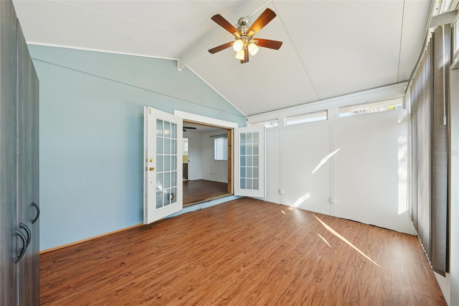 Unfinished Bonus room with vaulted ceiling, French doors from bedroom and access to back yard.