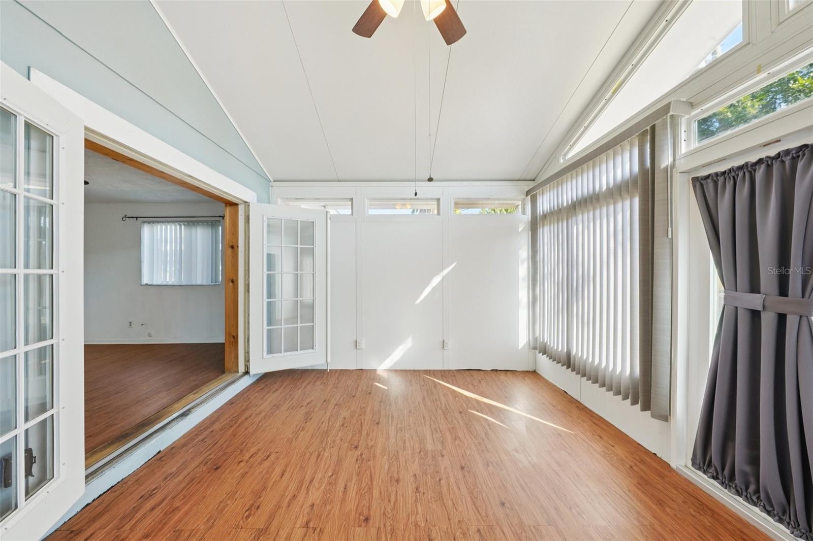 Unfinished Bonus room with vaulted ceiling, French doors from bedroom and access to back yard.