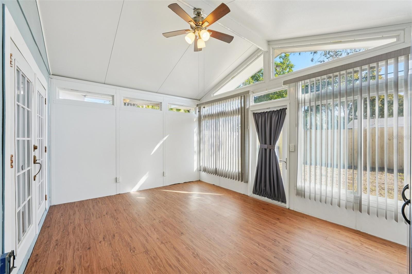 Unfinished Bonus room with vaulted ceiling, French doors from bedroom and access to back yard.