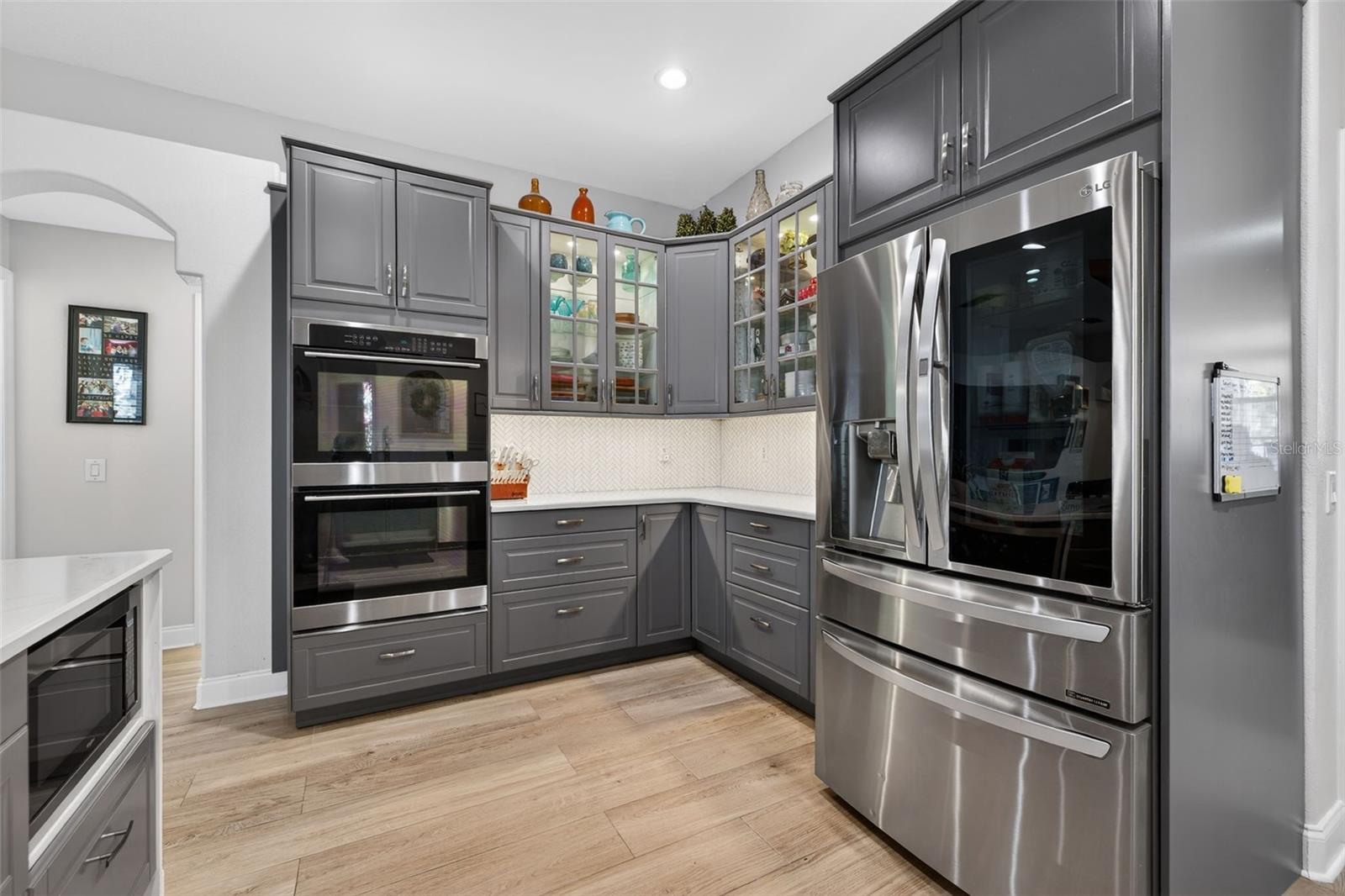 Kitchen with stainless steel Double built in ranges, supersized french door refrigerator