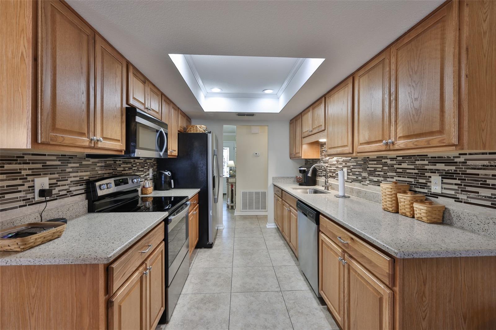 Modern Mosaic back splash, newer stainless, matching appliances and tons of storage make this kitchen a dream.