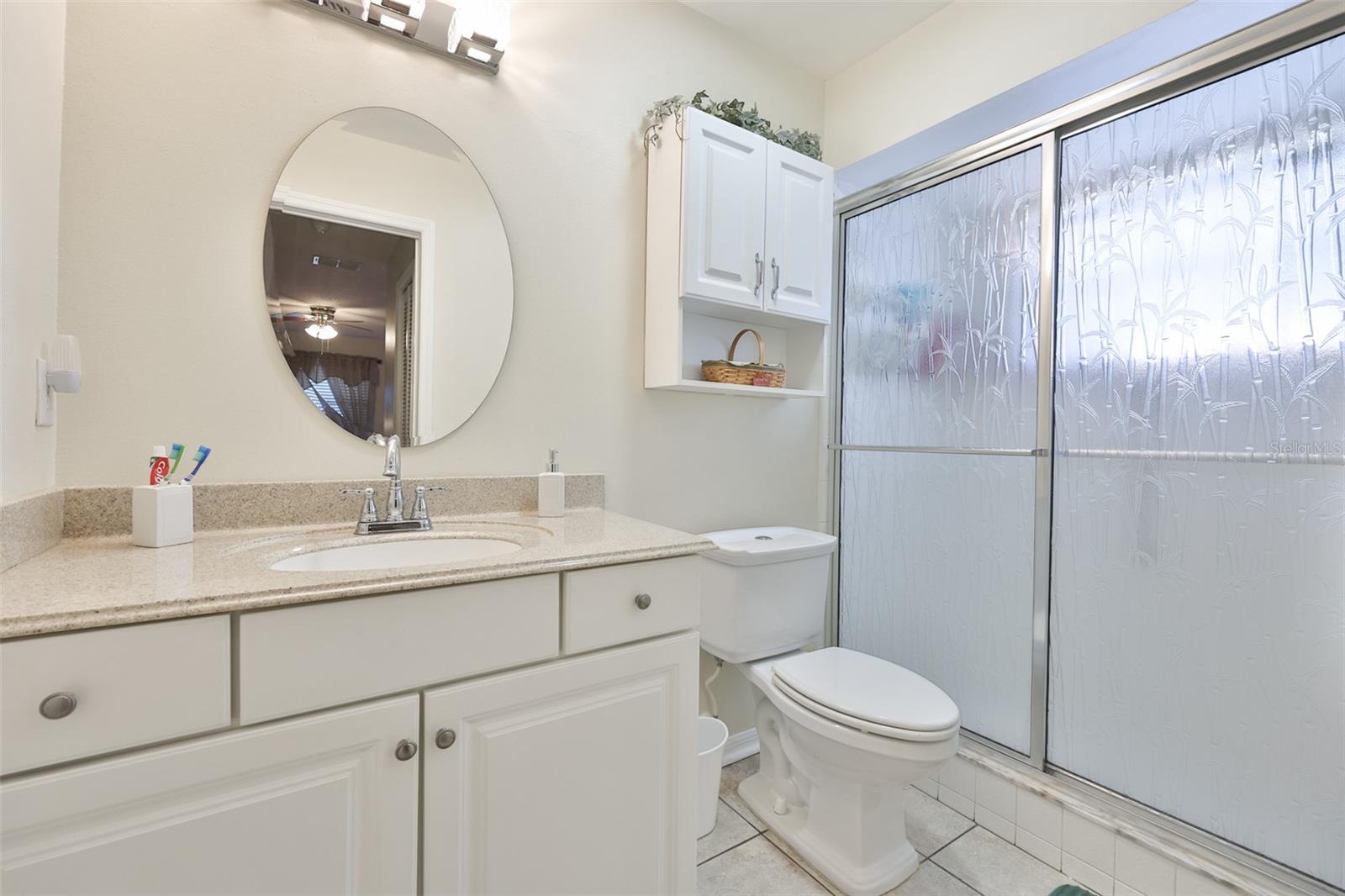 Primary bedroom is good size with walk in shower and updated stone counters and high toilet.
