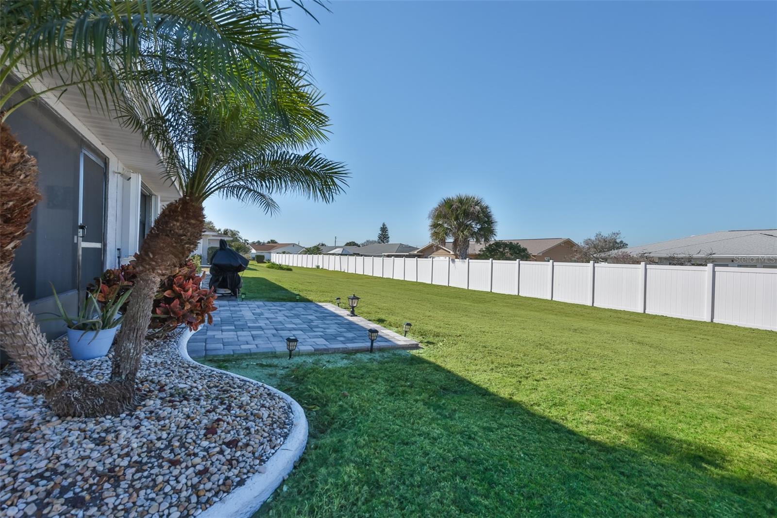 Large backyard with open air patio for grilling or entertaining.